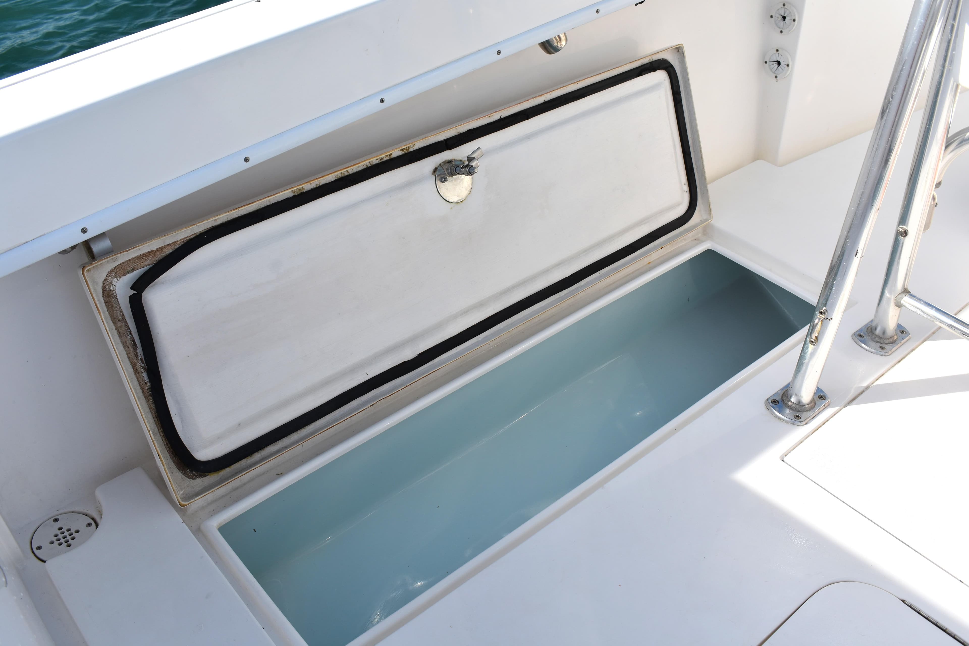 Open storage compartment on a 2014 Contender 23 Open boat deck.