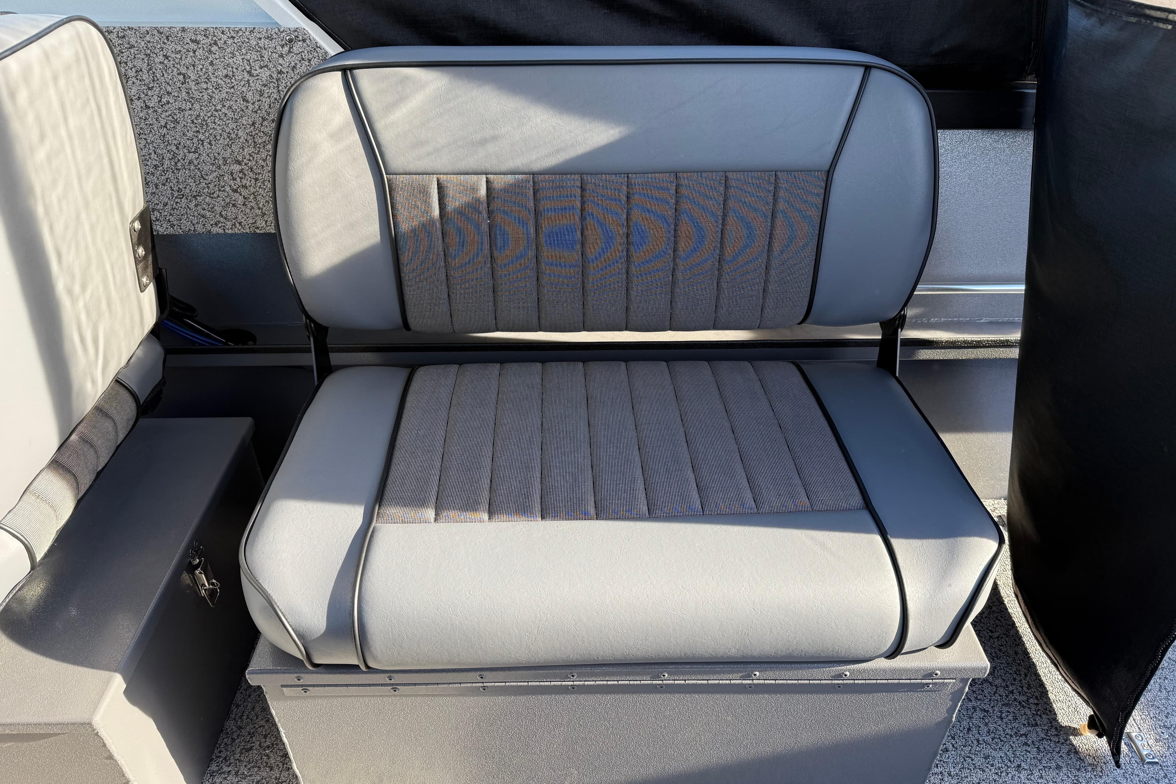 2026 Alumaweld Stryker 202 boat seat with gray upholstery and storage compartment.