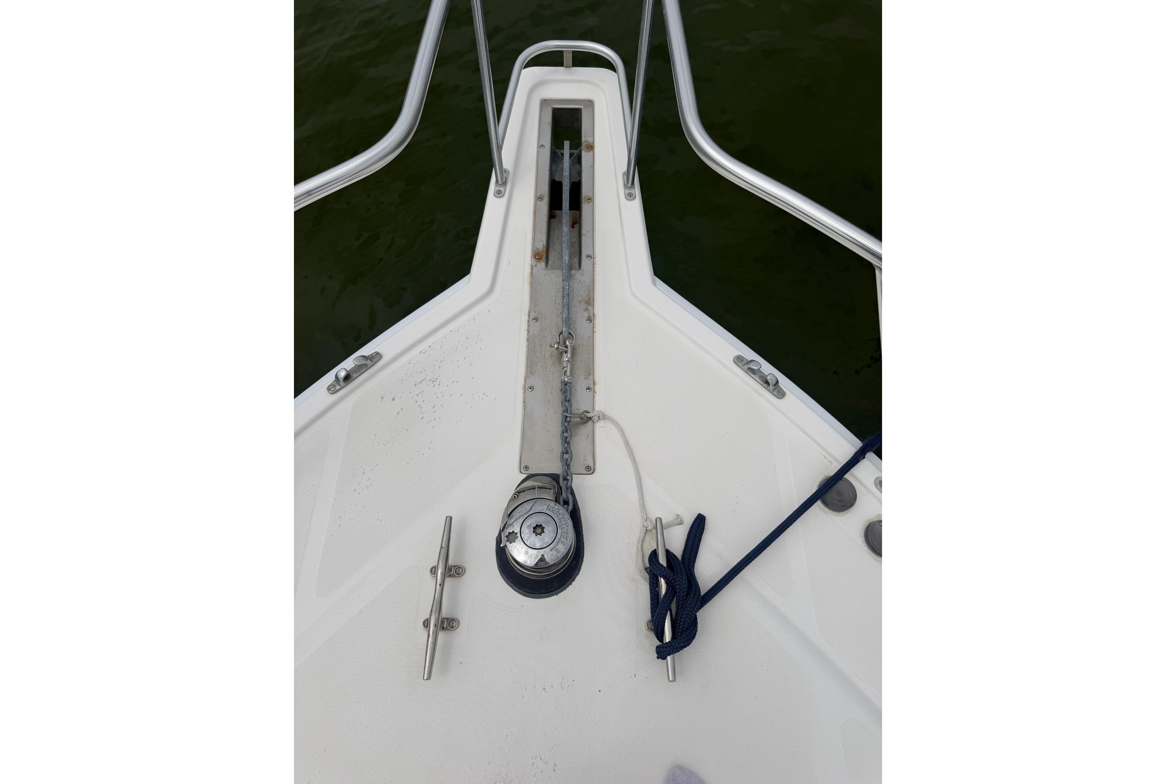 Bow of 2003 Cabo 35 Express boat with anchor chain and cleats.
