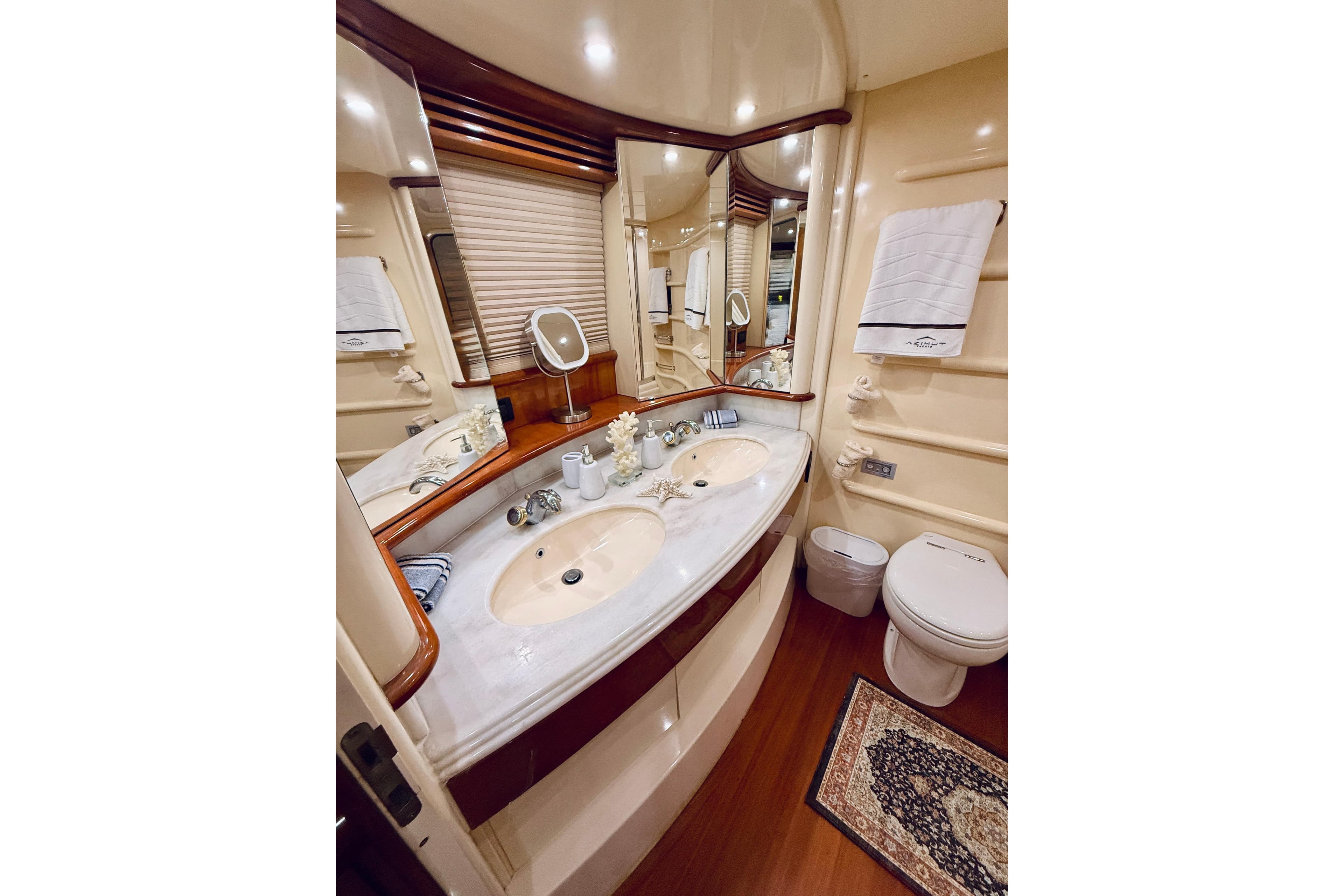 Luxurious bathroom in 2007 Azimut 68E yacht with dual sinks and elegant decor.