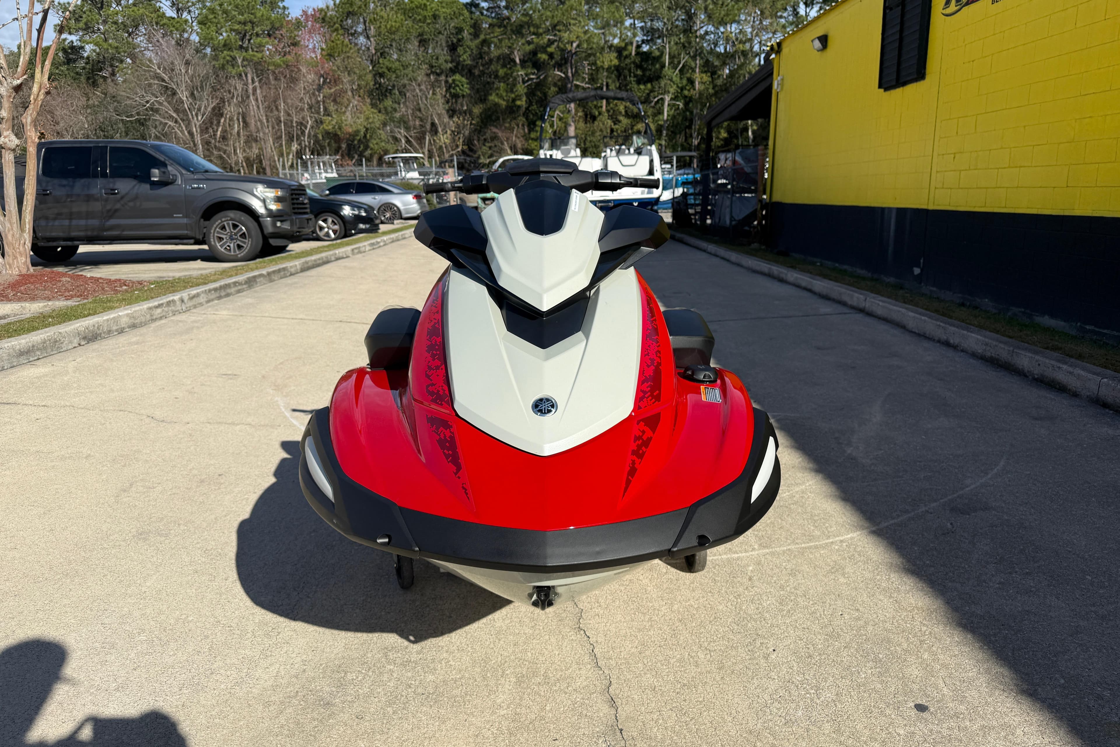 2026 Yamaha WaveRunner VX Cruiser in vibrant red, parked outdoors on a sunny day.