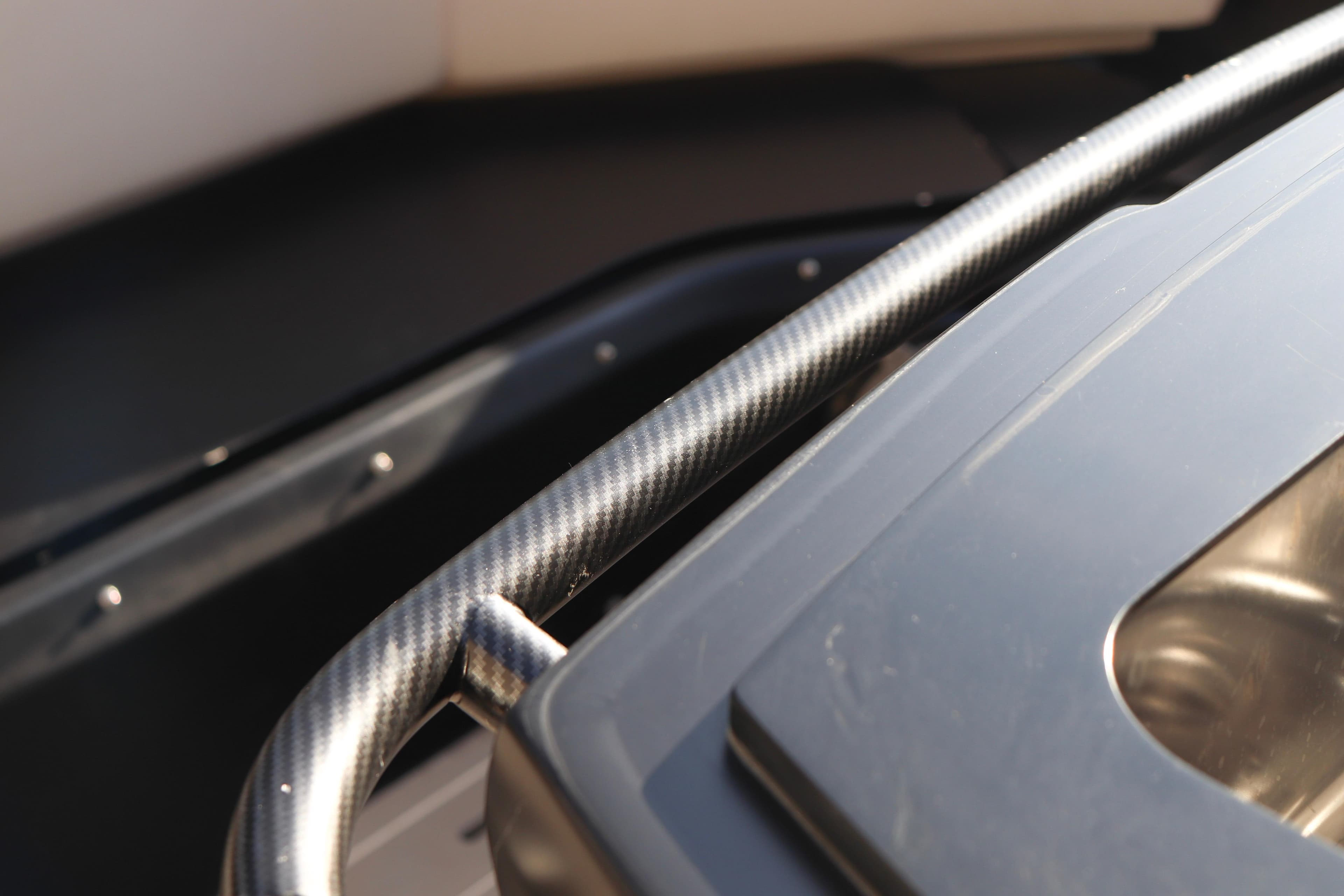 Close-up of 2021 SACS Strider 11 OB Opendeck's sleek carbon fiber detail.