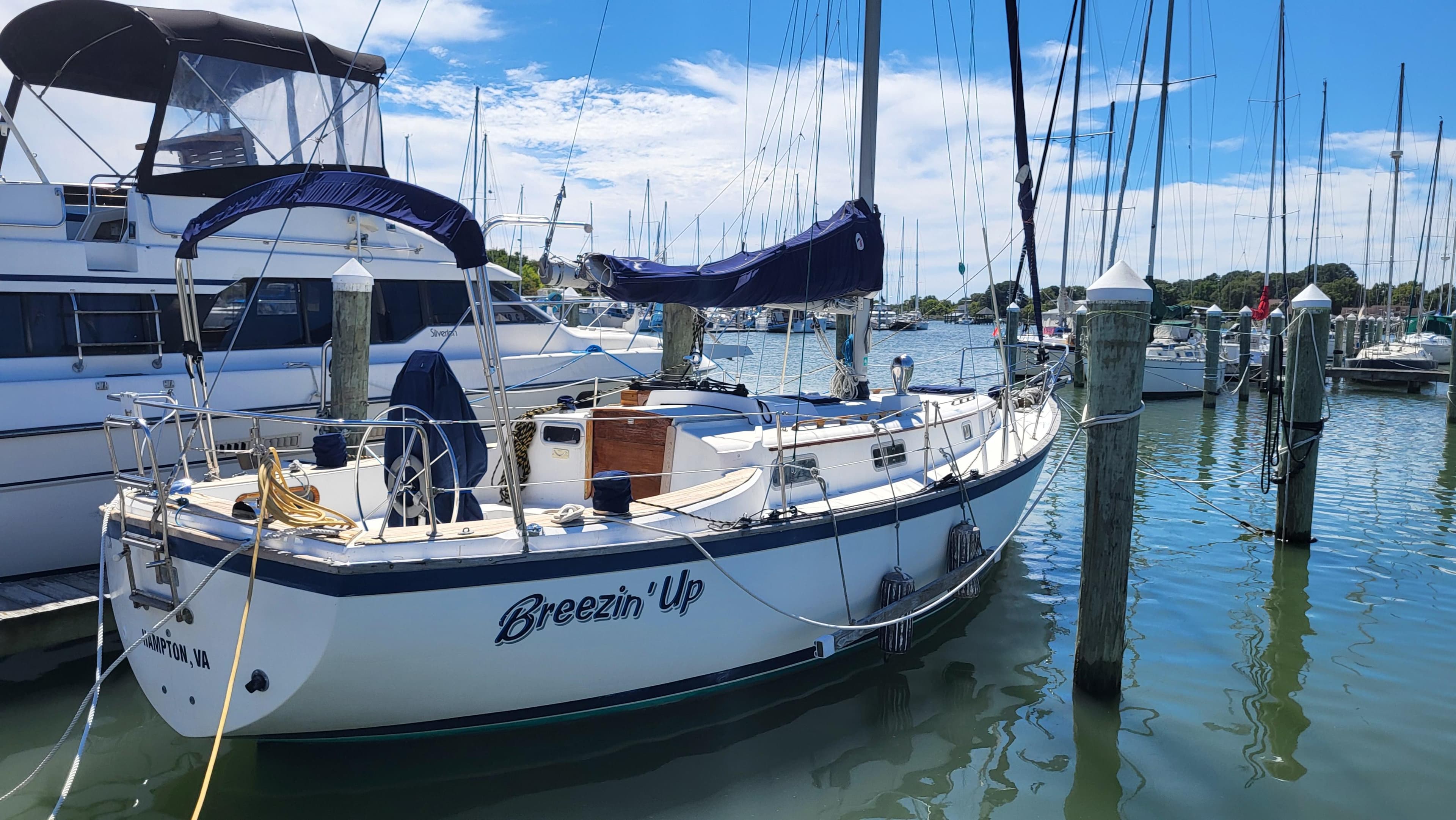 1979 Pearson 365 Sloop sailboat docked in marina, named "Breezin' Up."