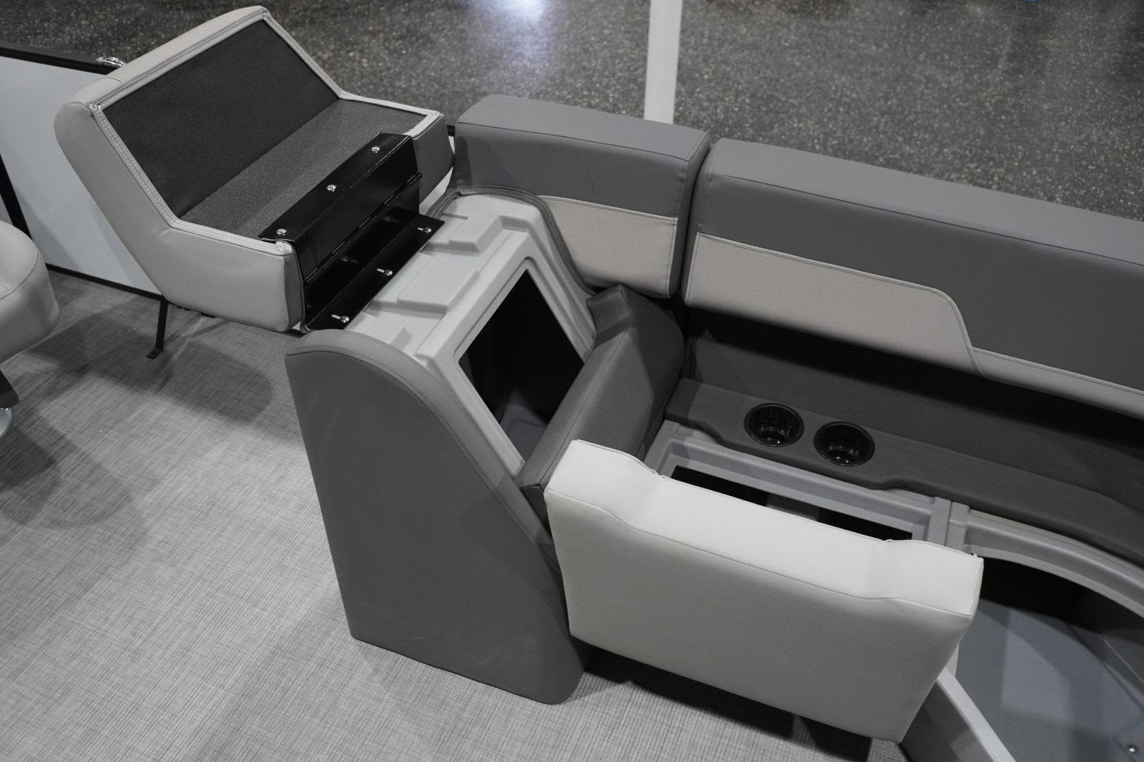 Interior seating and storage of 2026 Lowe LS 190 boat, featuring cup holders and gray upholstery.
