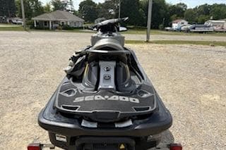 2017 Sea-Doo GTX 155 jet ski parked on gravel lot, rear view.