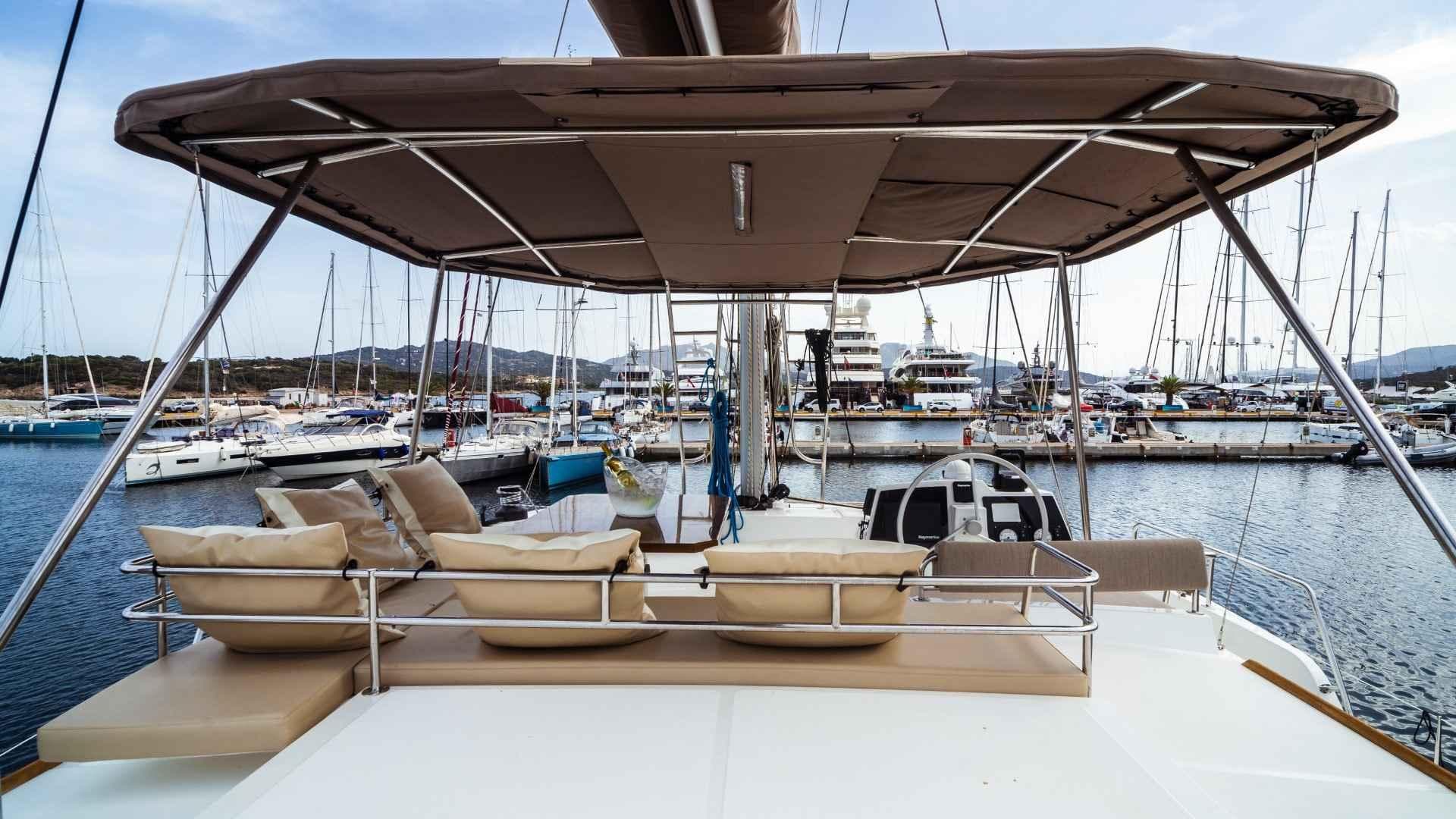 Luxurious Bali 4.8 yacht docked at marina, featuring spacious deck and comfortable seating.