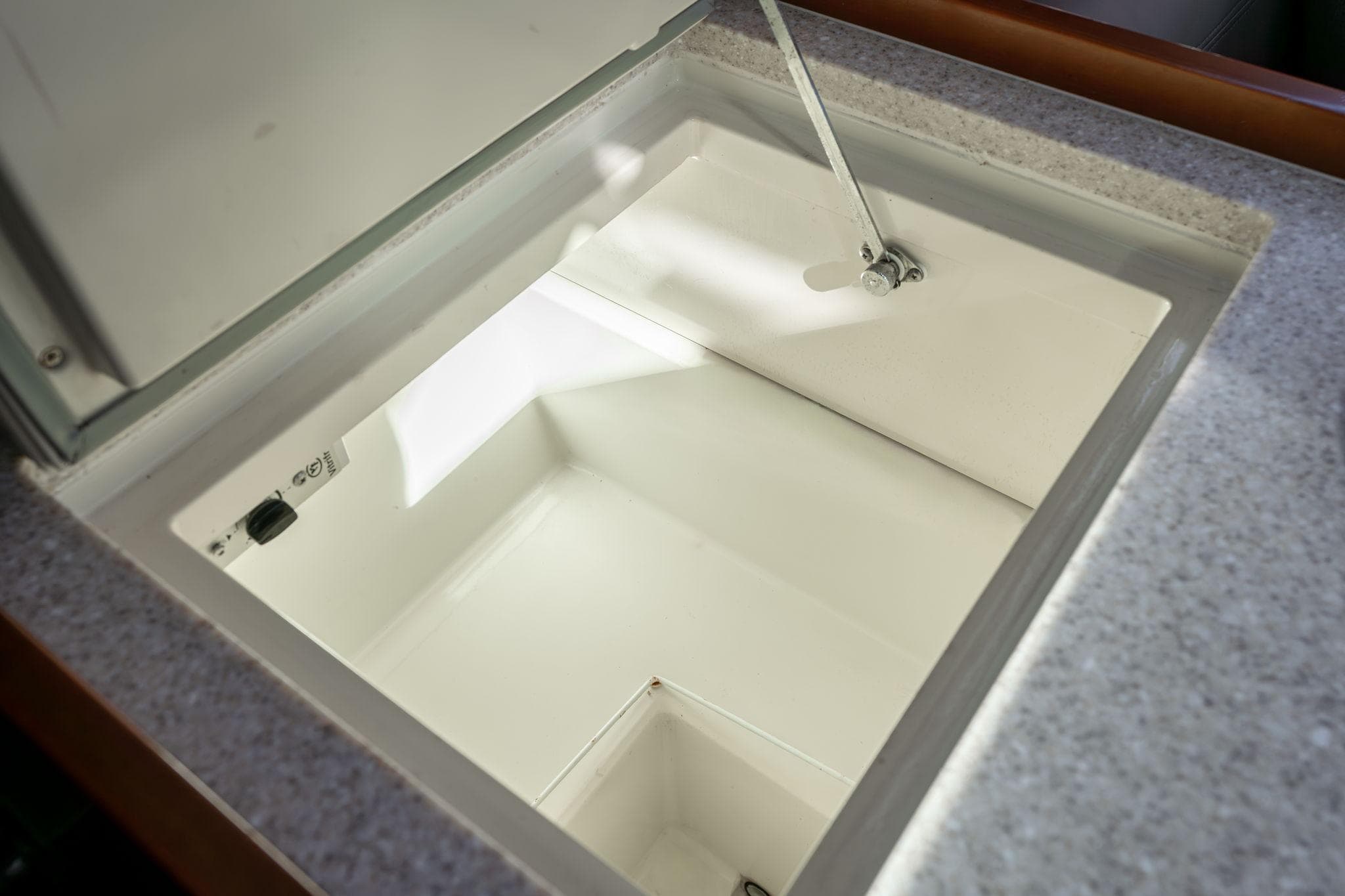 Beneteau Oceanis 50 (2013) yacht interior storage compartment, open lid view.