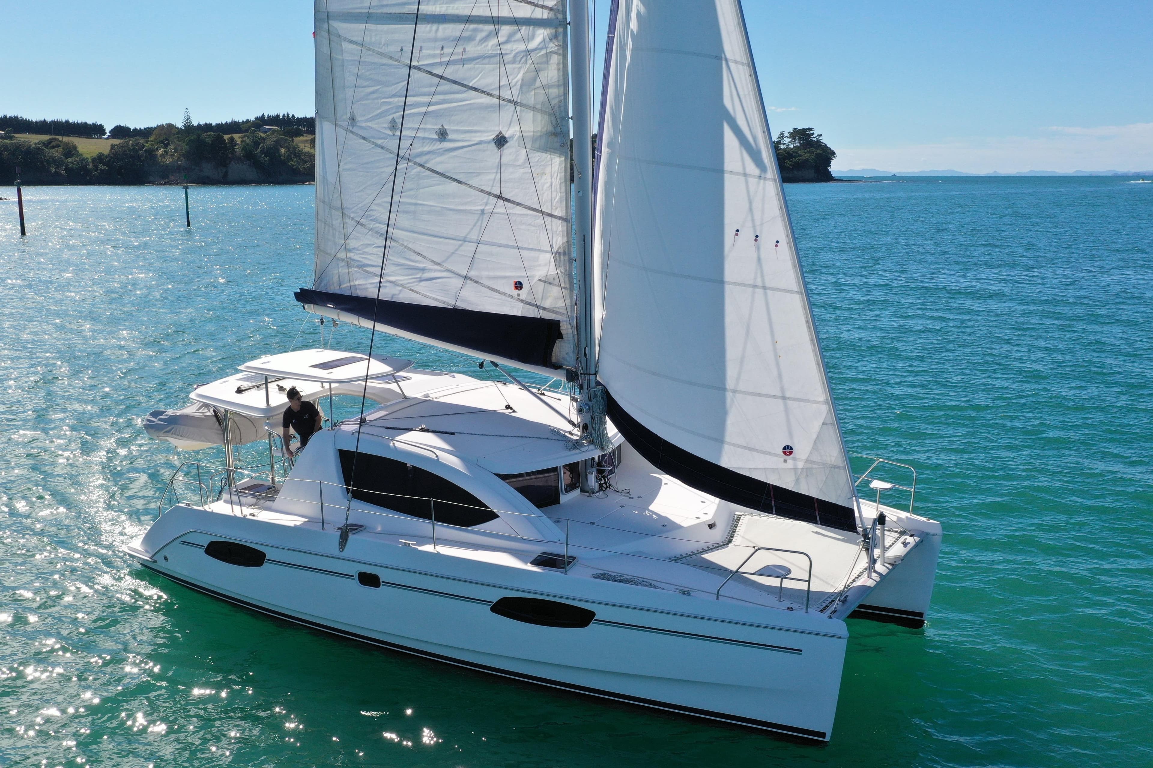 2012 Leopard 39 owners version catamaran sailing on clear blue waters.