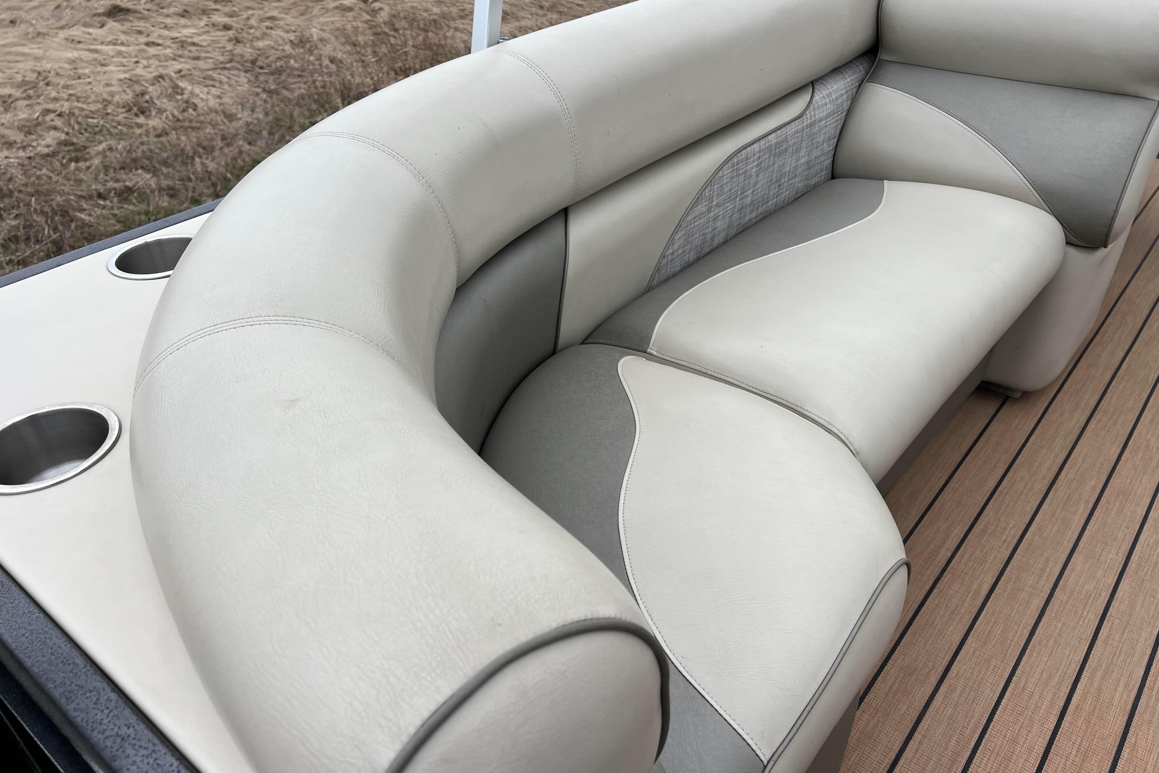 Luxurious seating on 2017 Premier 230 SunSation RF boat with cup holders and stylish design.