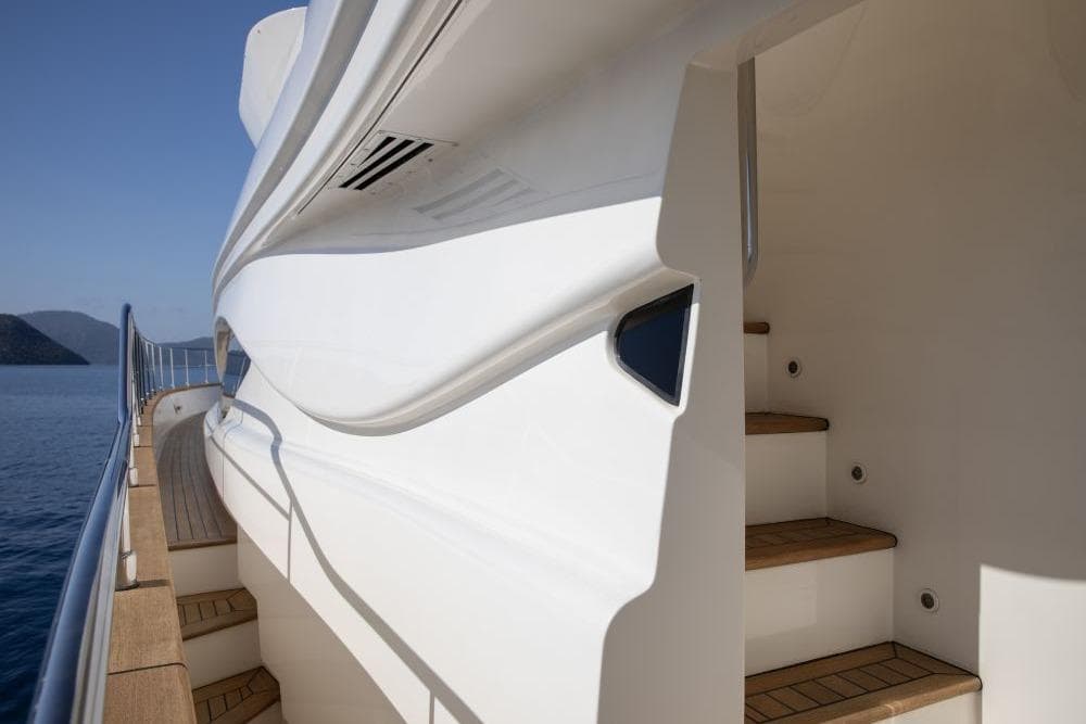 Luxurious CRN 129 yacht deck and stairs, 2009 model, with sleek white design.