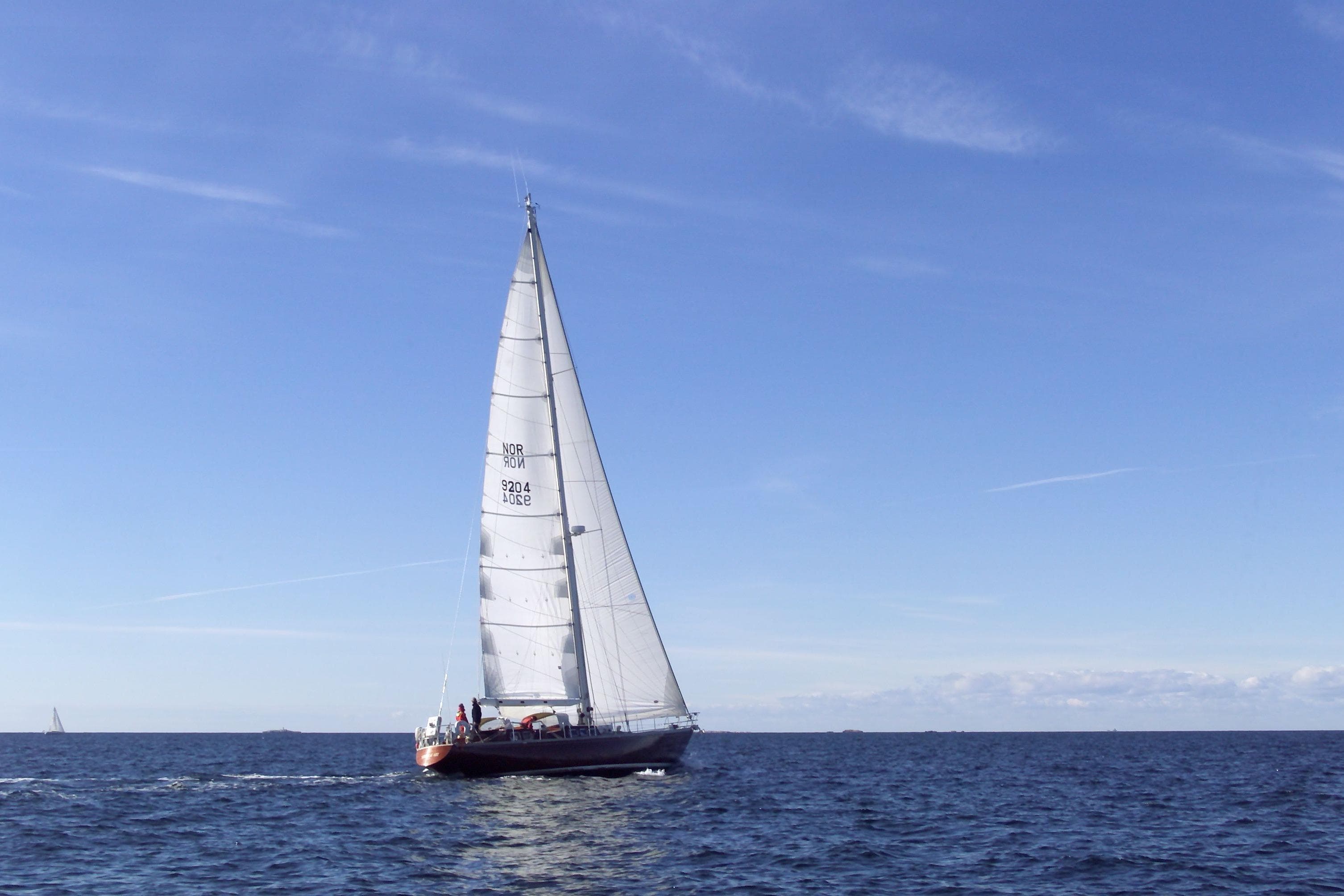 Sailing yacht "Cantiere Valdettaro Le Grazie" from 1977 on open sea under clear blue sky.