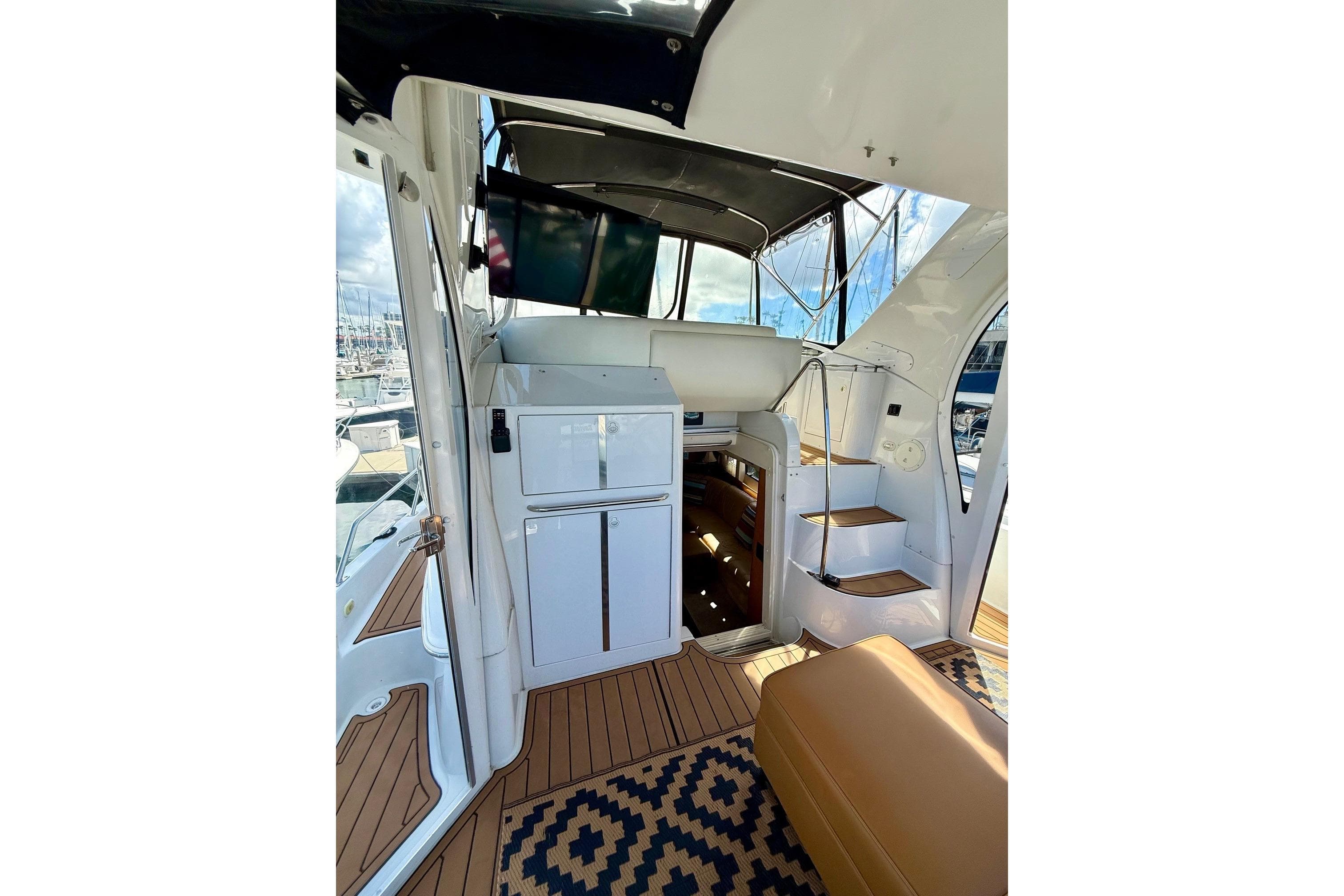 Interior view of 2001 Carver 444 Cockpit Motor Yacht with stairs and seating area.