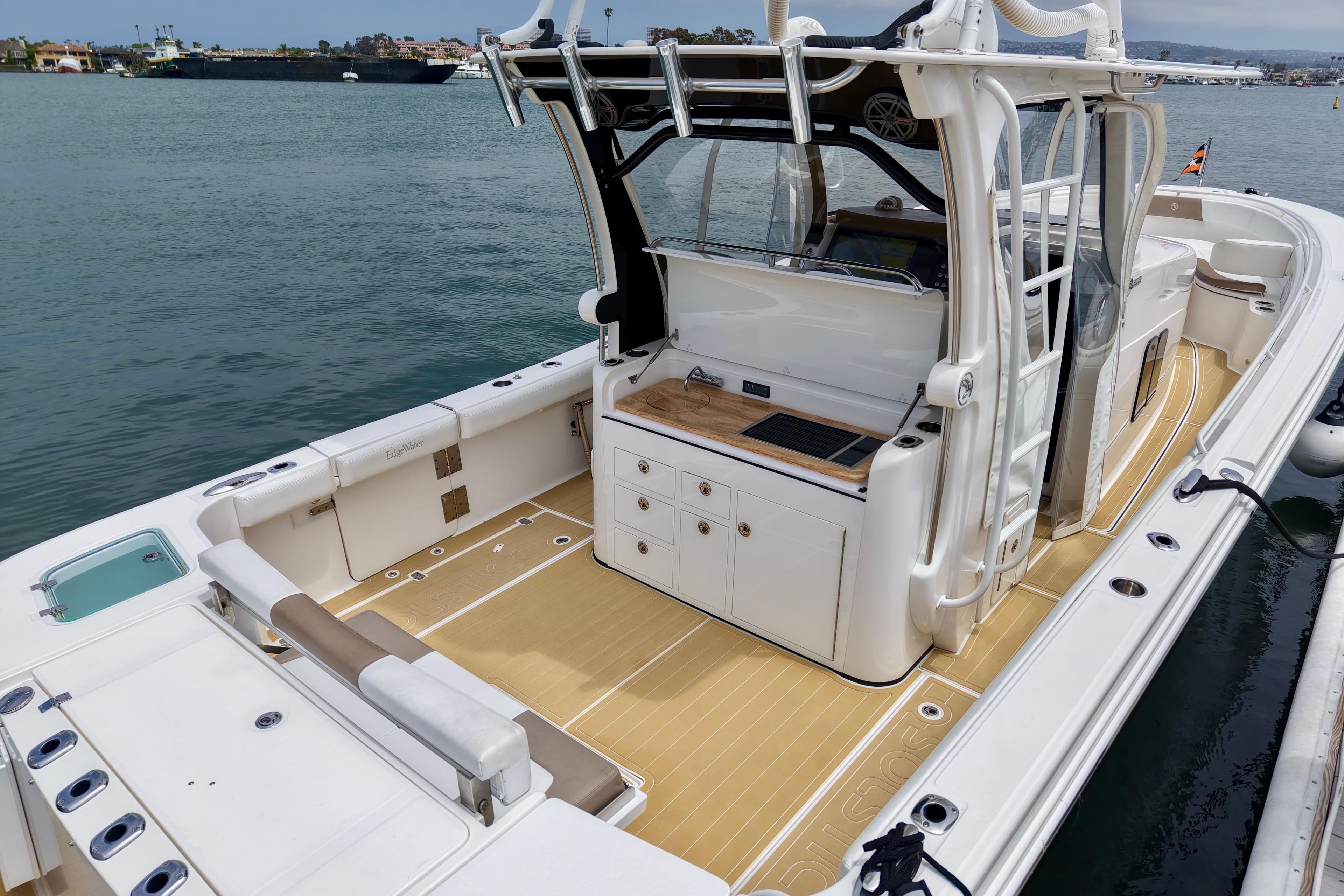 2016 Edgewater 368CC boat with spacious deck and modern amenities, docked by the water.