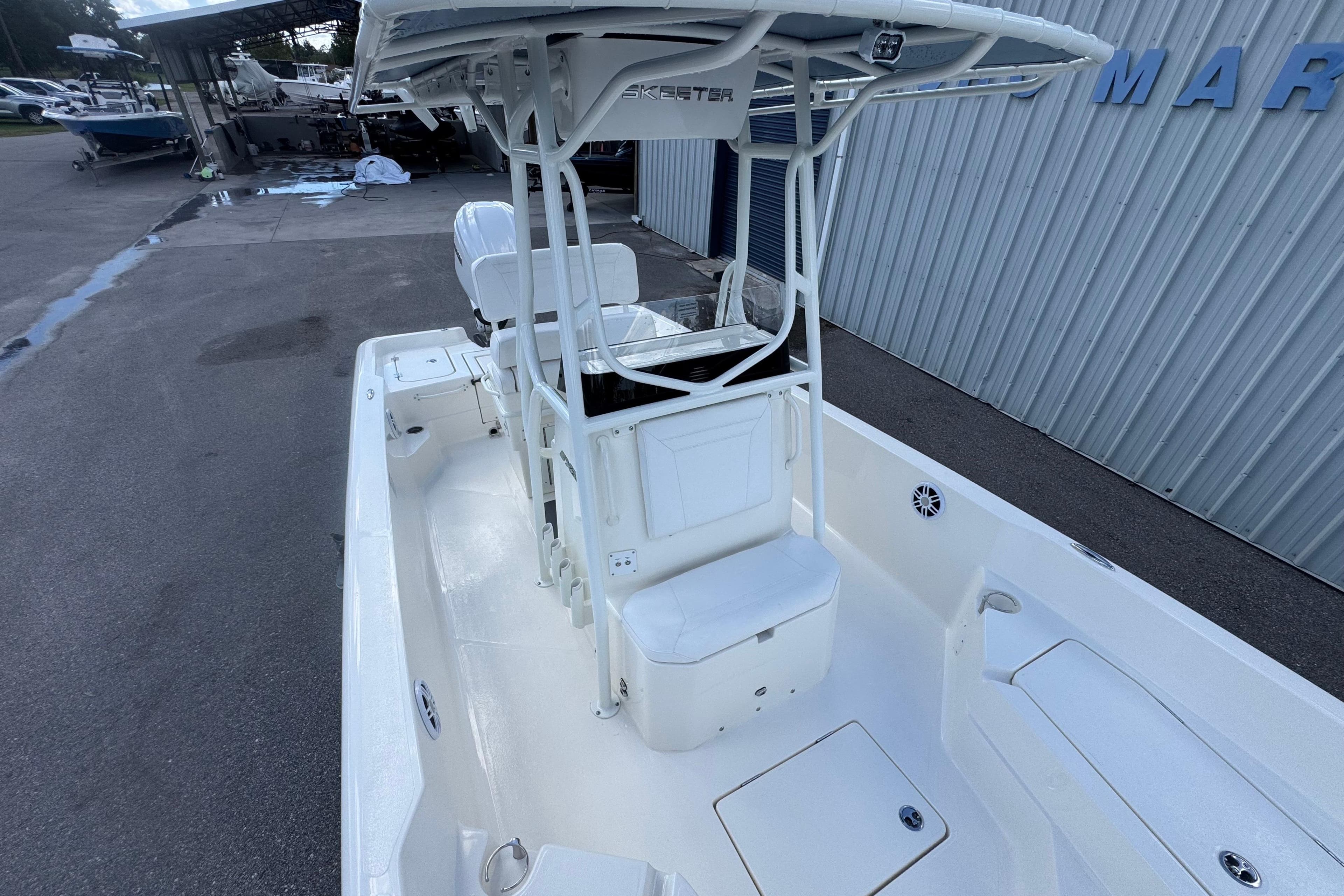 2026 Skeeter SX2350 boat with T-top, white interior, docked at marina.