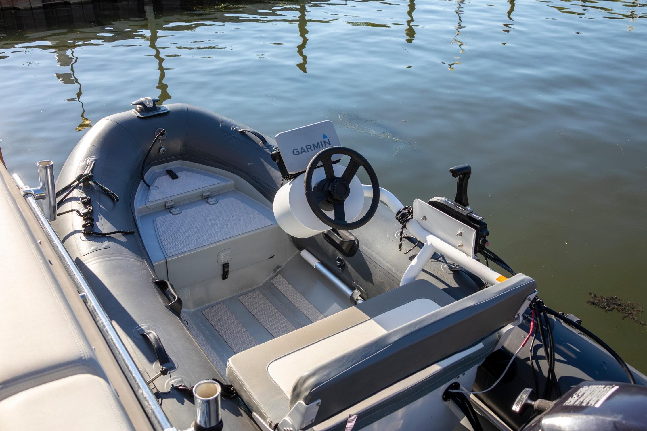 Inflatable boat with Garmin steering, docked beside Cranchi Eco Trawler 53 Long Distance, 2018 model.