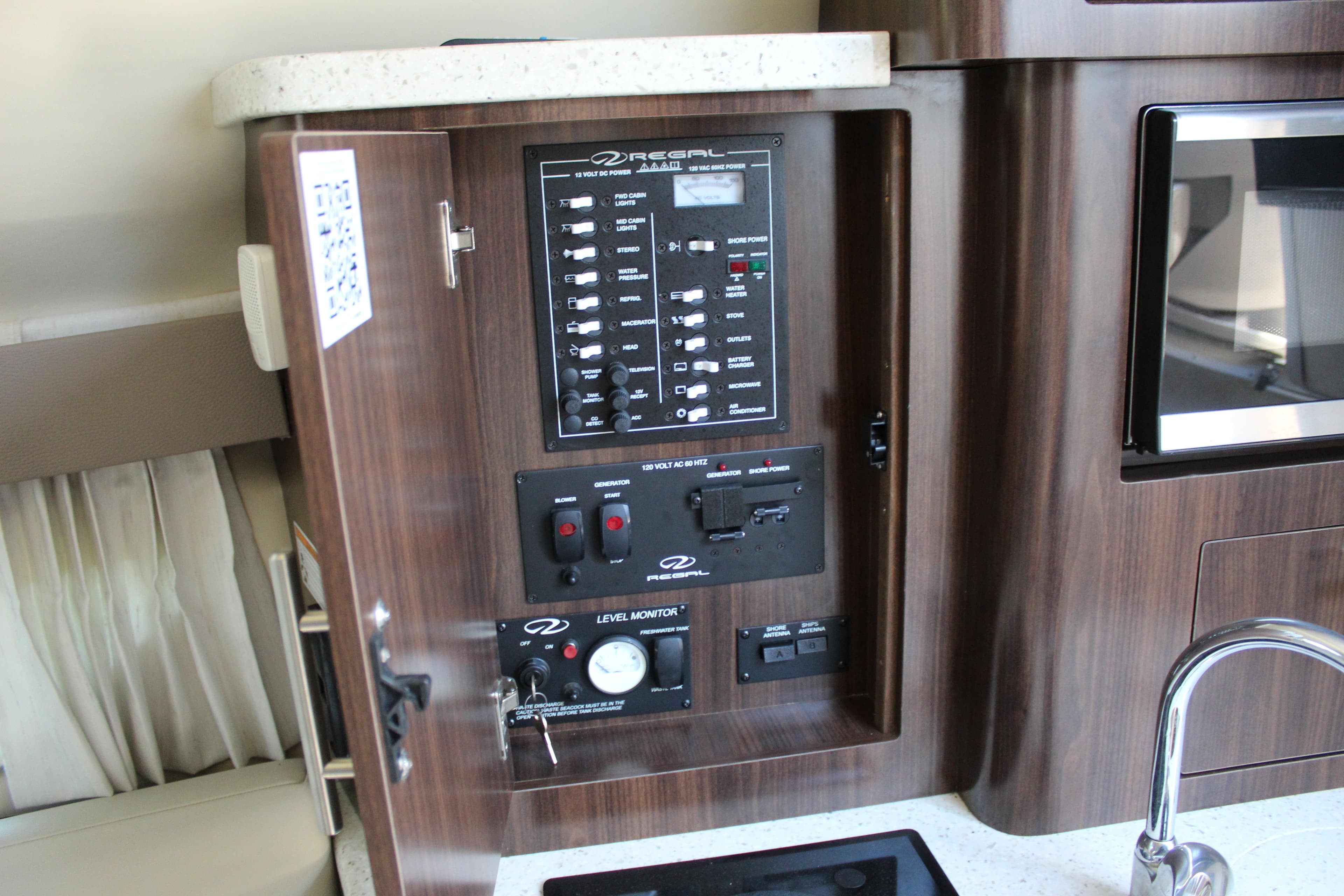 Control panel inside a 2018 Regal 28 Express boat, featuring switches and gauges.