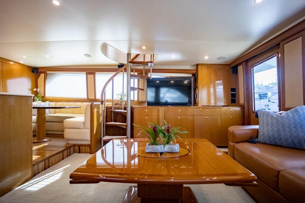 Luxurious interior of 2003 Viking 65 EB yacht with elegant wood finishes and modern amenities.