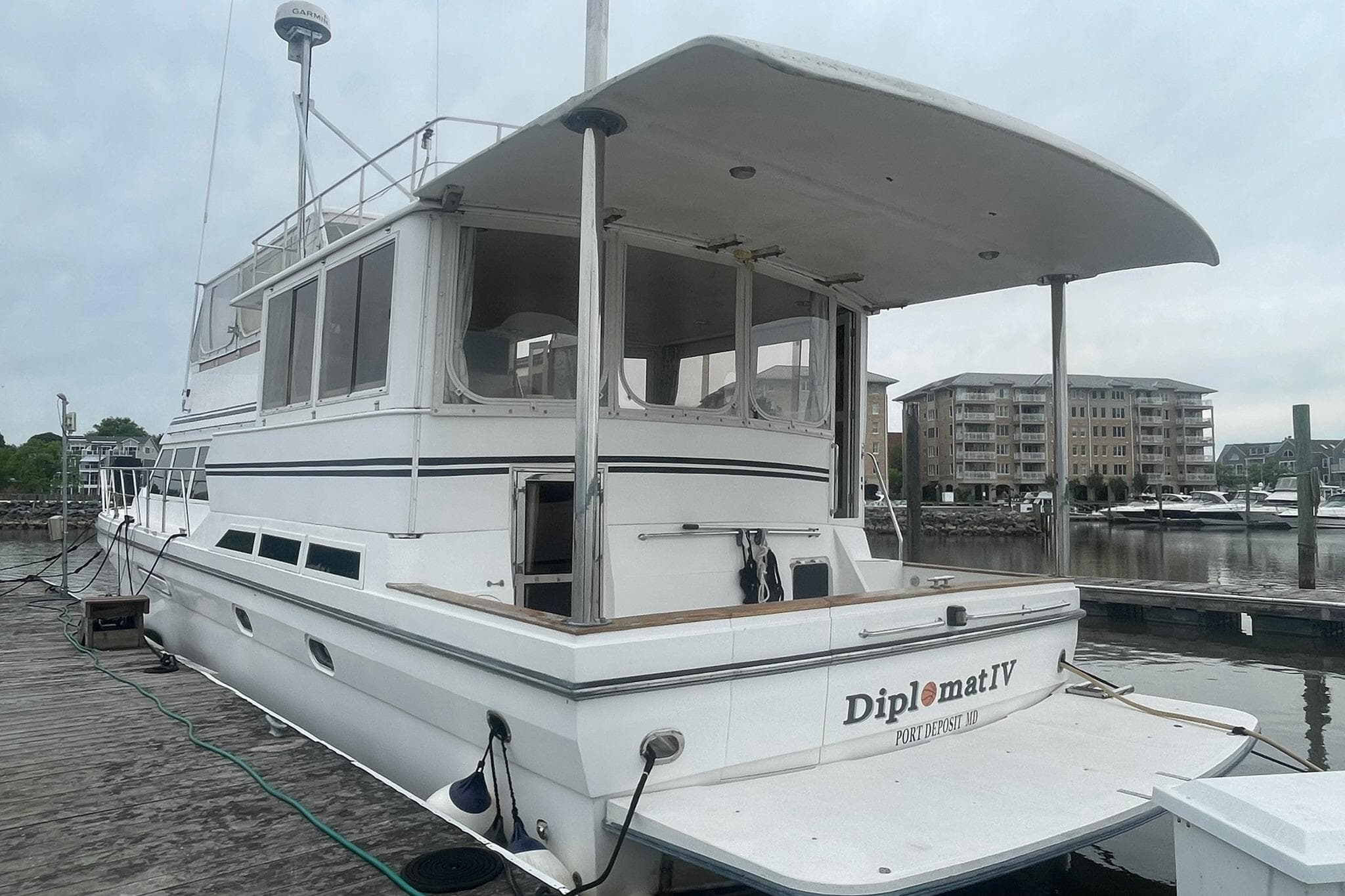 Novatec Islander 2001 yacht docked at marina, featuring spacious deck and modern design.