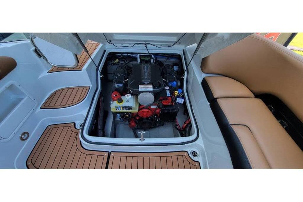 2024 Crownline Eclipse E235 boat engine compartment with tan seating and teak flooring.