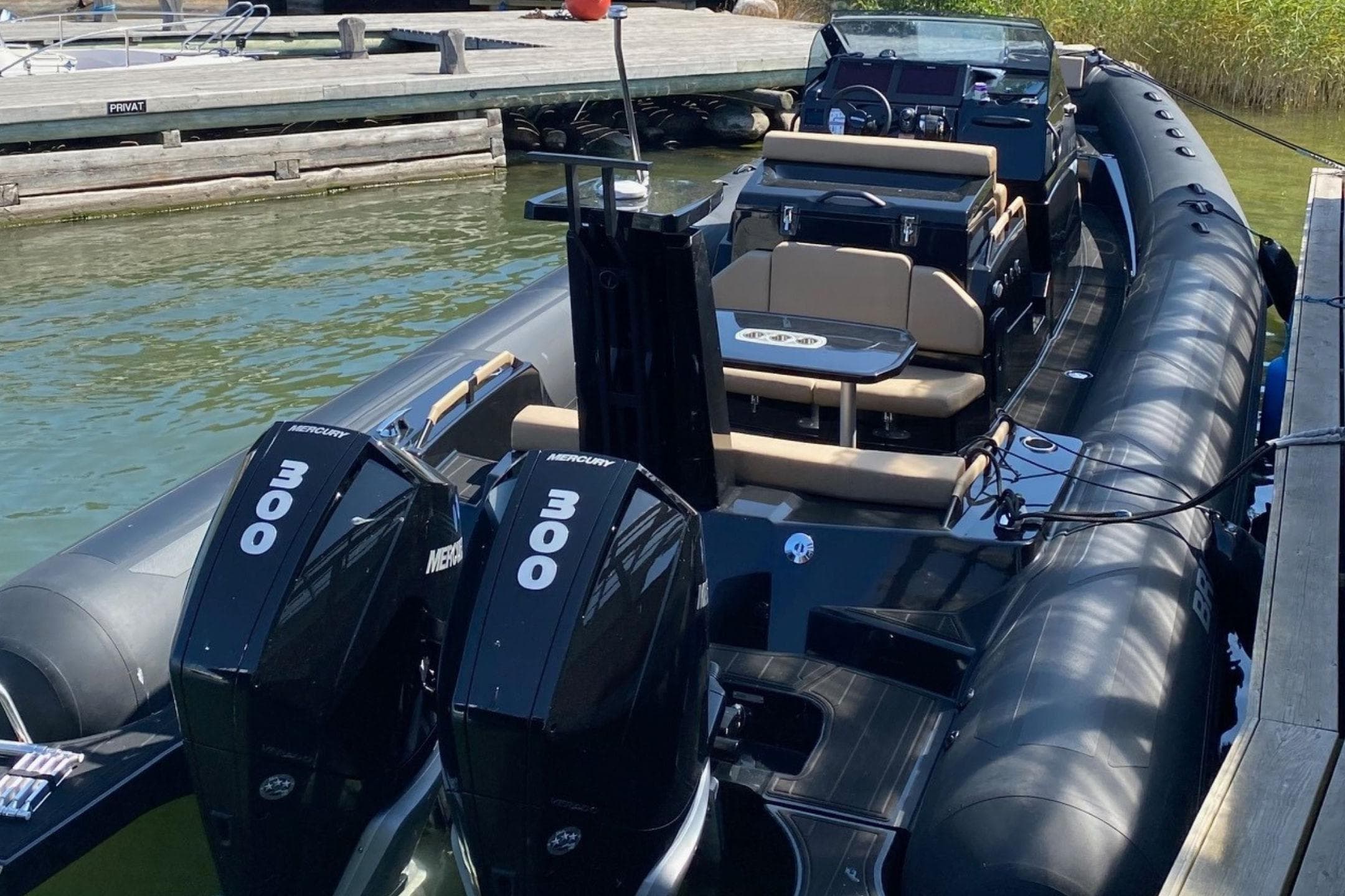 2021 Brig Eagle 10 boat with dual Mercury 300 engines docked at a marina.