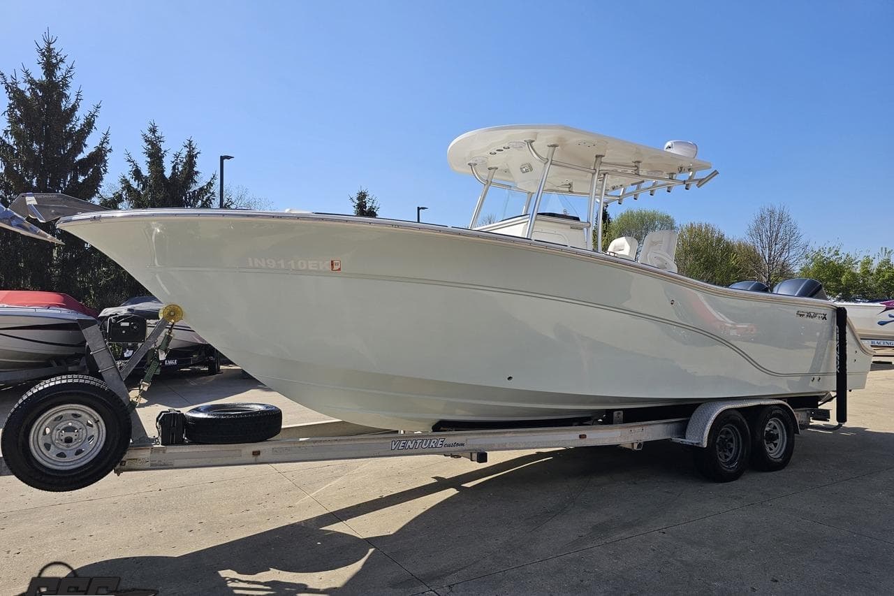 2013 Sea Fox 286 Commander boat on trailer under clear blue sky.