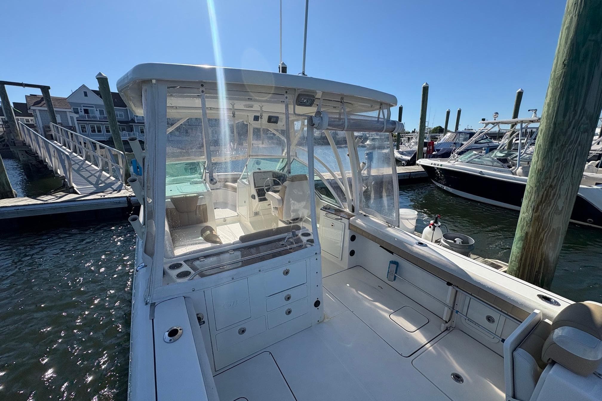 2016 Glacier Bay 2740 Dual Console boat docked at marina under clear blue sky.