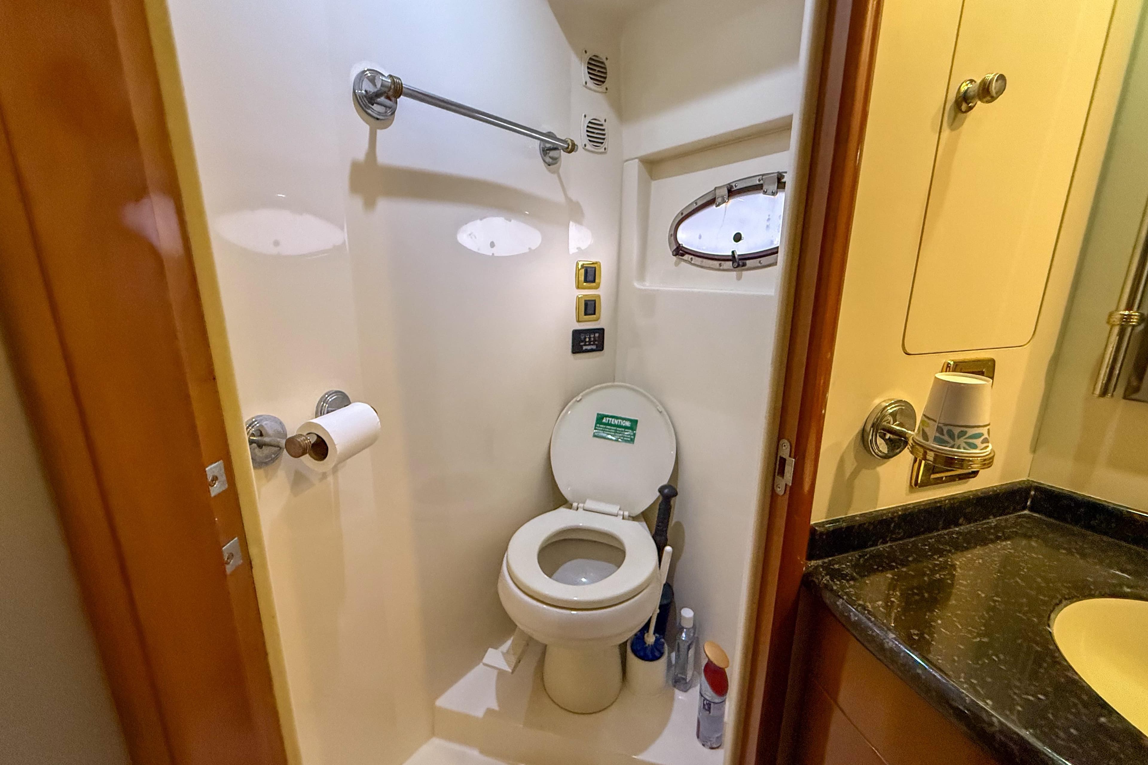 Bathroom in 2001 Carver 570 Voyager Pilothouse yacht, featuring toilet and sink.