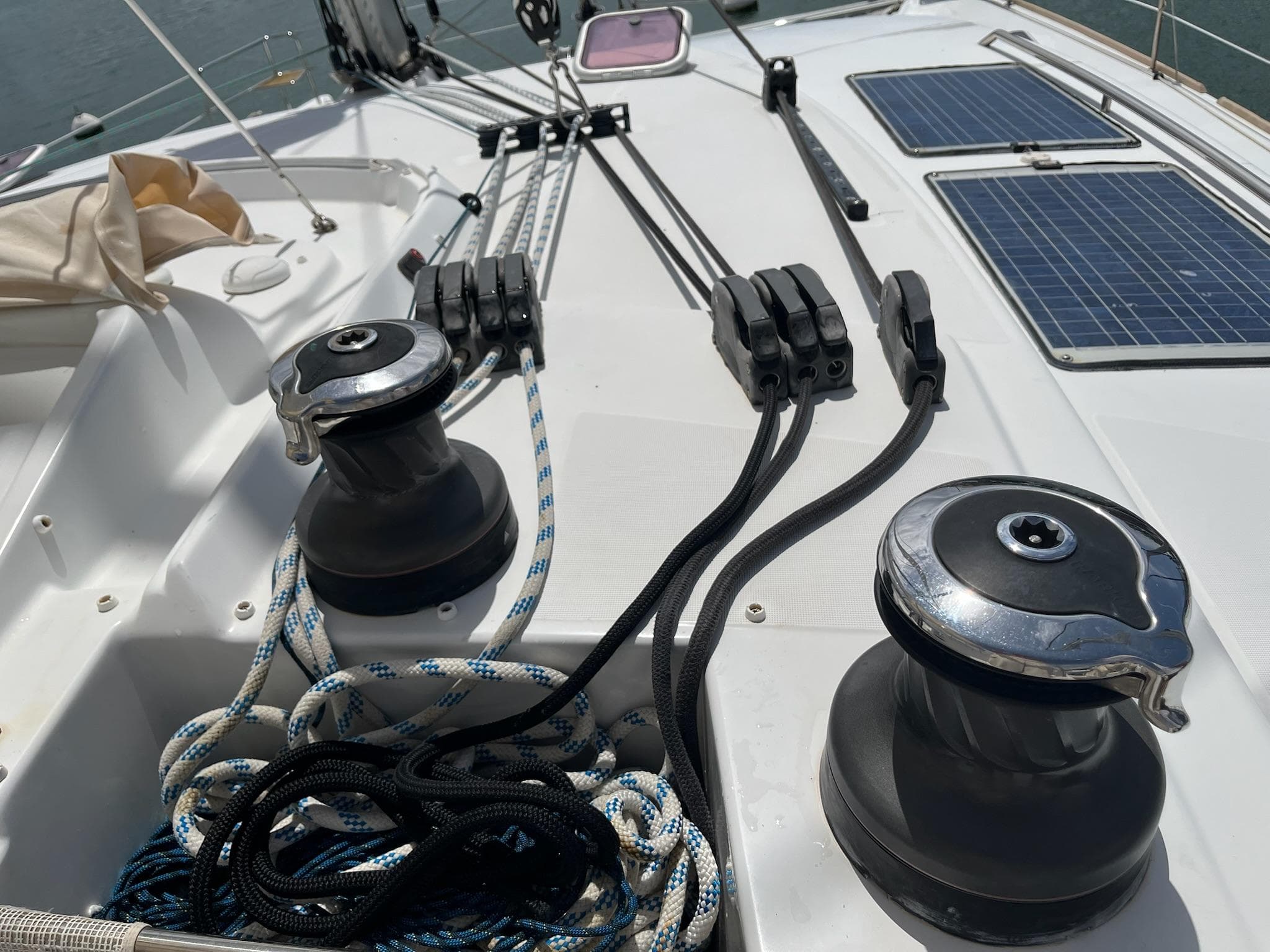 Deck of 2009 Lagoon 440 catamaran with winches, ropes, and solar panels.