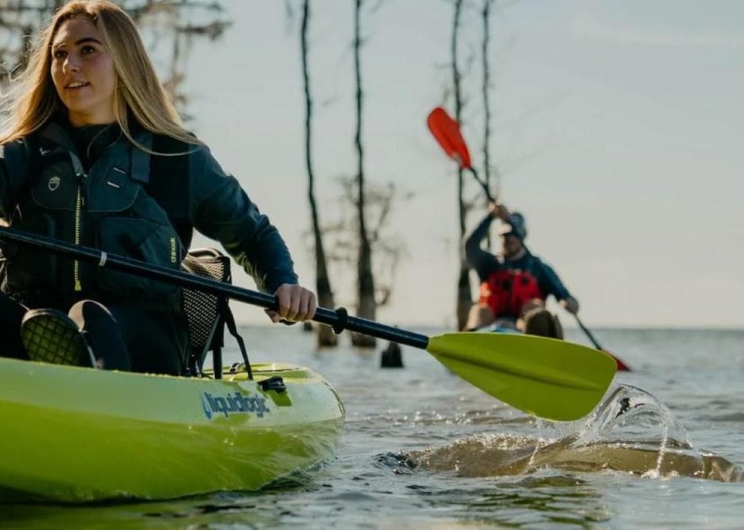 Two people kayaking on a lake with Liquidlogic Kiawah 12 kayaks, 2023 model.