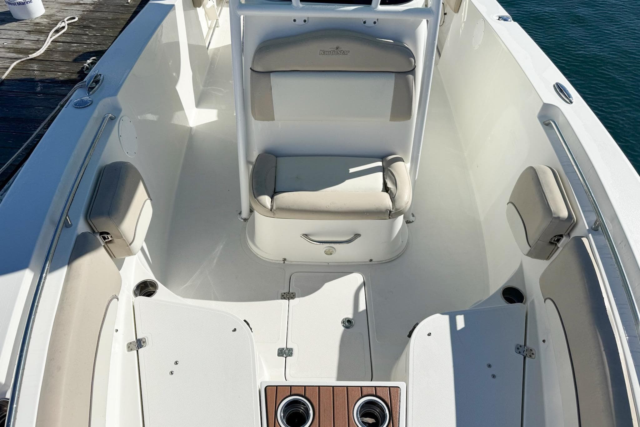 2017 NauticStar 2602 Legacy boat interior with cushioned seating and storage compartments.