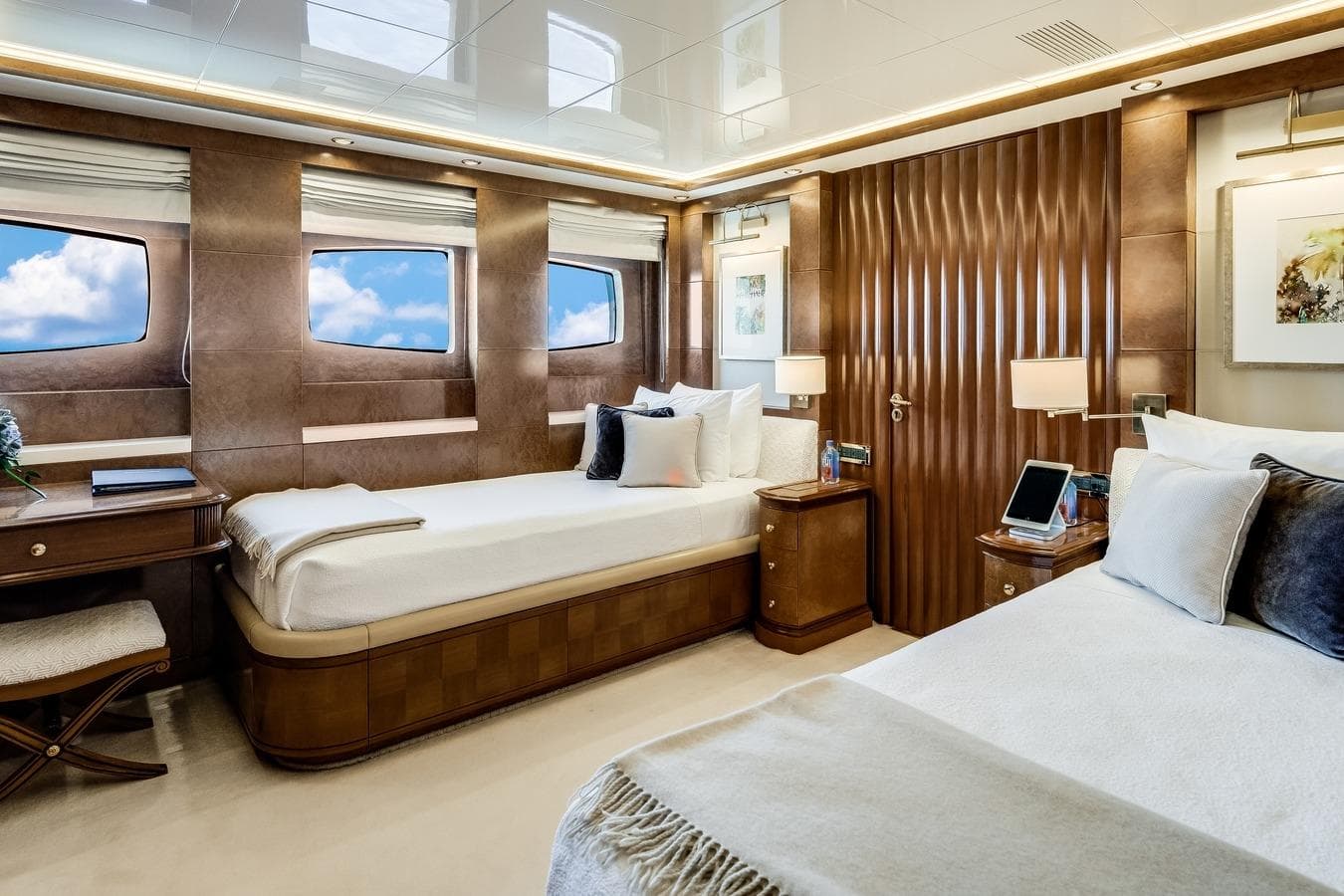 Luxurious Mondomarine 2006 motor yacht bedroom with elegant wood paneling and twin beds.