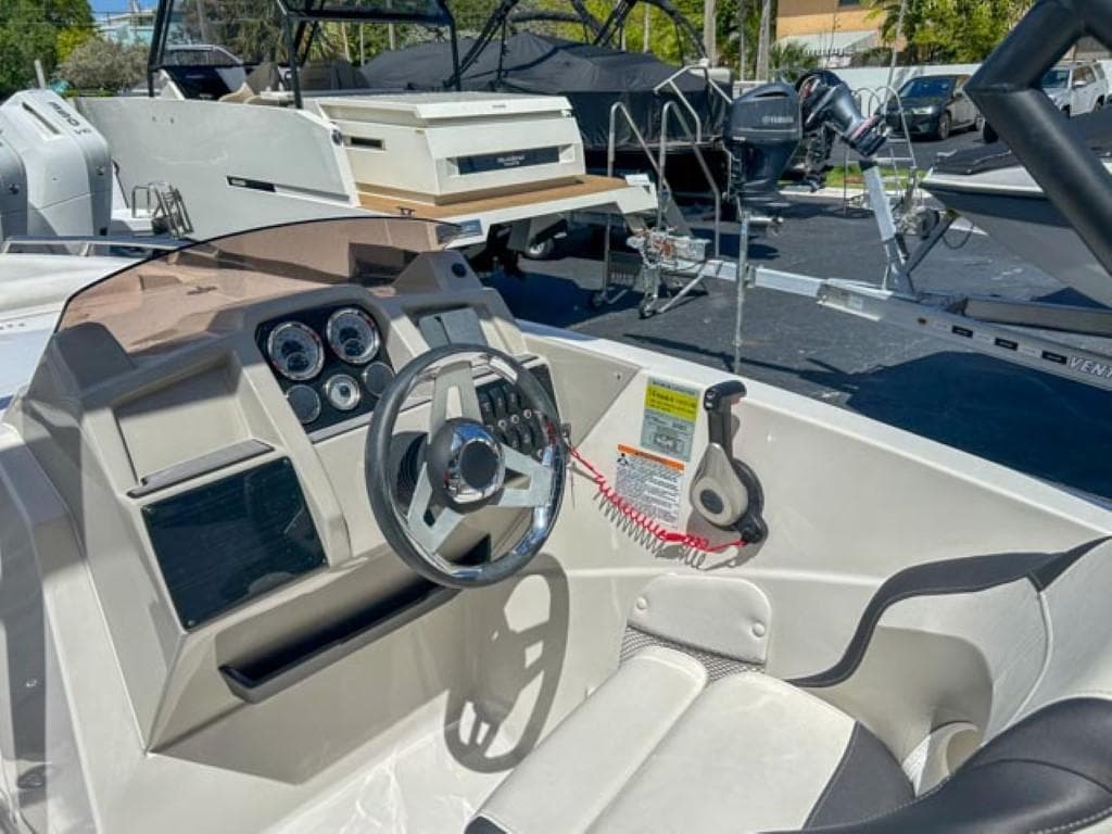 2024 Starcraft SVX 231 OB DH boat dashboard with steering wheel and controls.