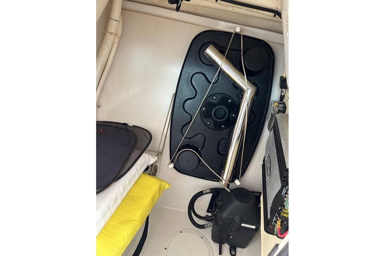 Interior view of a 2016 Sailfish 275 DC boat cabin with storage and equipment.