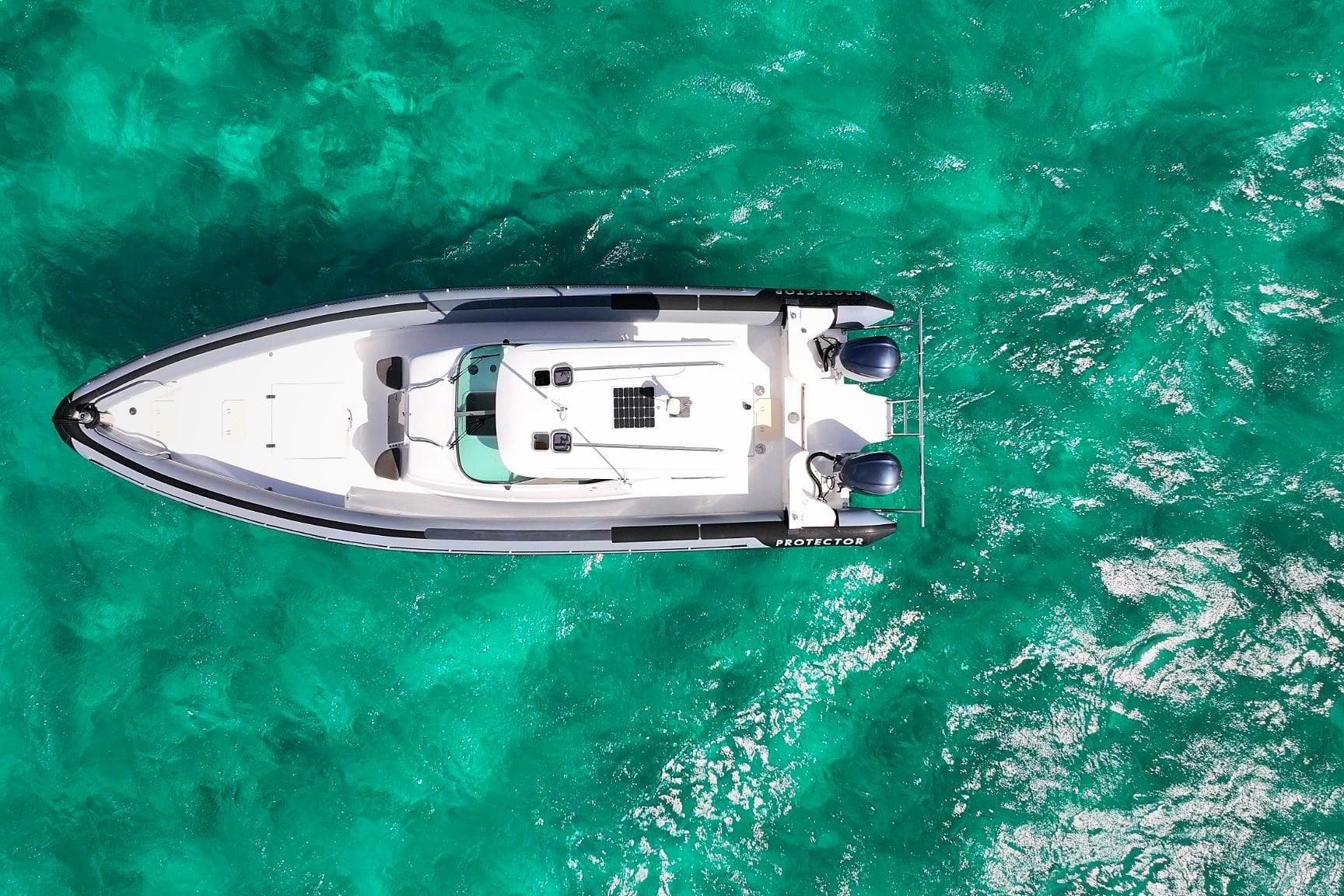 Aerial view of 2007 Protector Targa 35 boat on turquoise water.