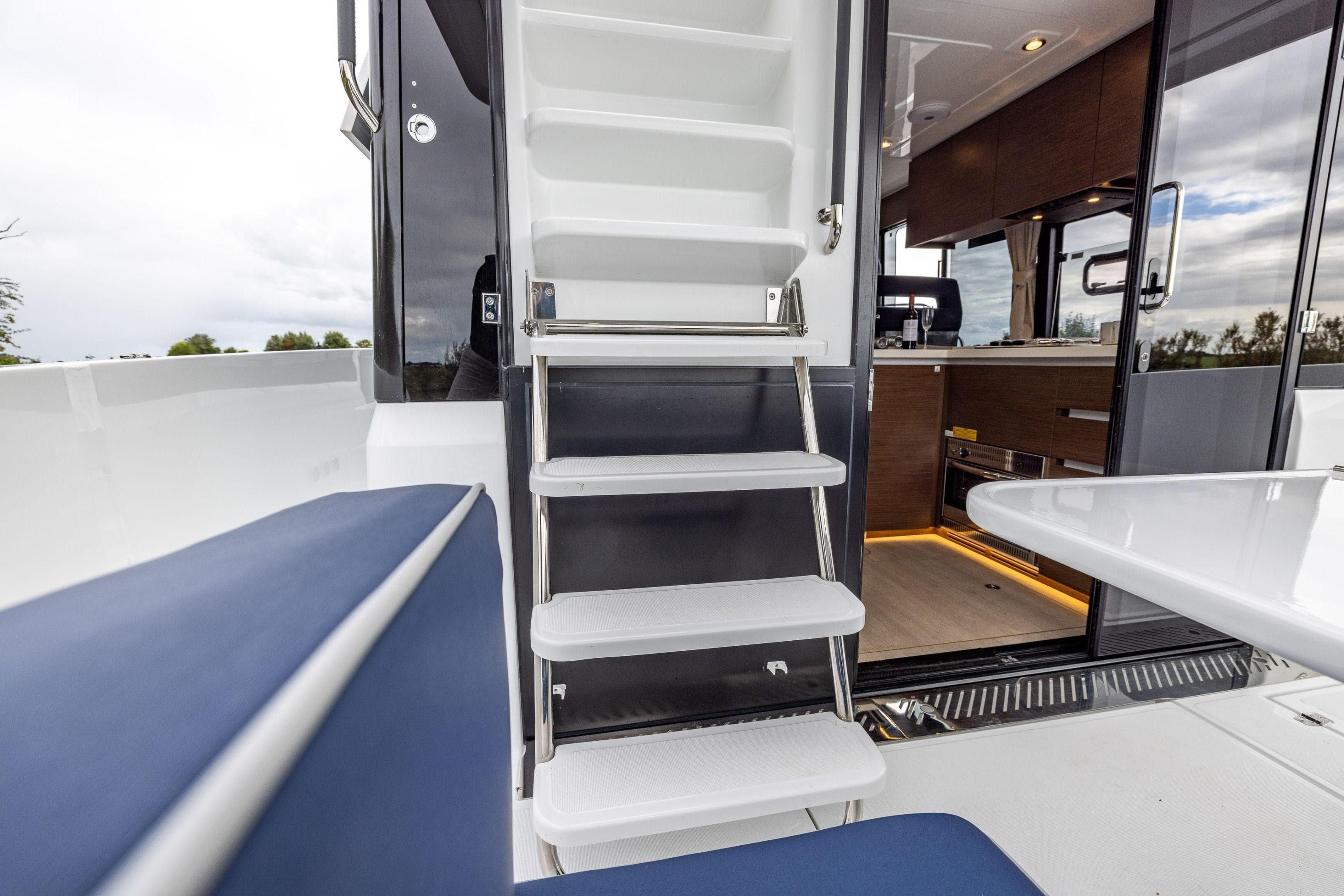 Interior view of 2026 Delphia D11 Flybridge yacht with stairs and modern kitchen.