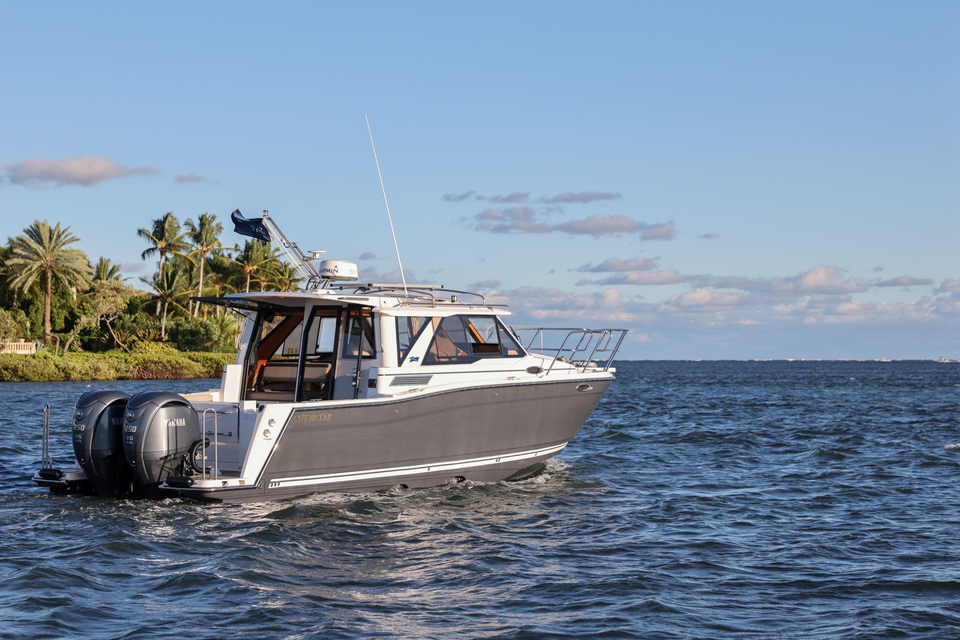 2026 Cutwater C-288 Coupe cruising on a sunny day, showcasing sleek design and powerful engines.