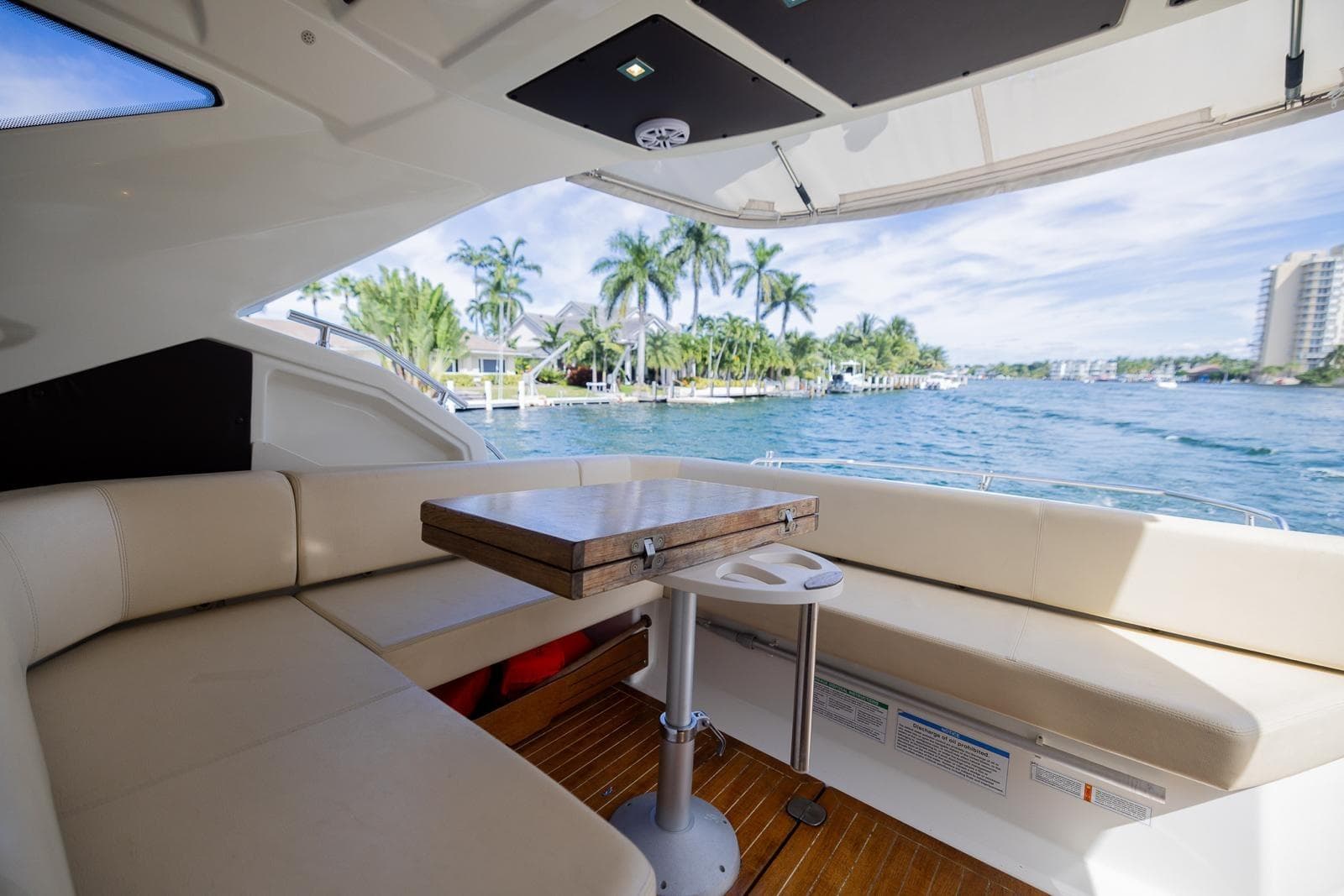 Luxurious 2014 Cranchi M 44 HT yacht interior with waterfront view and elegant seating area.