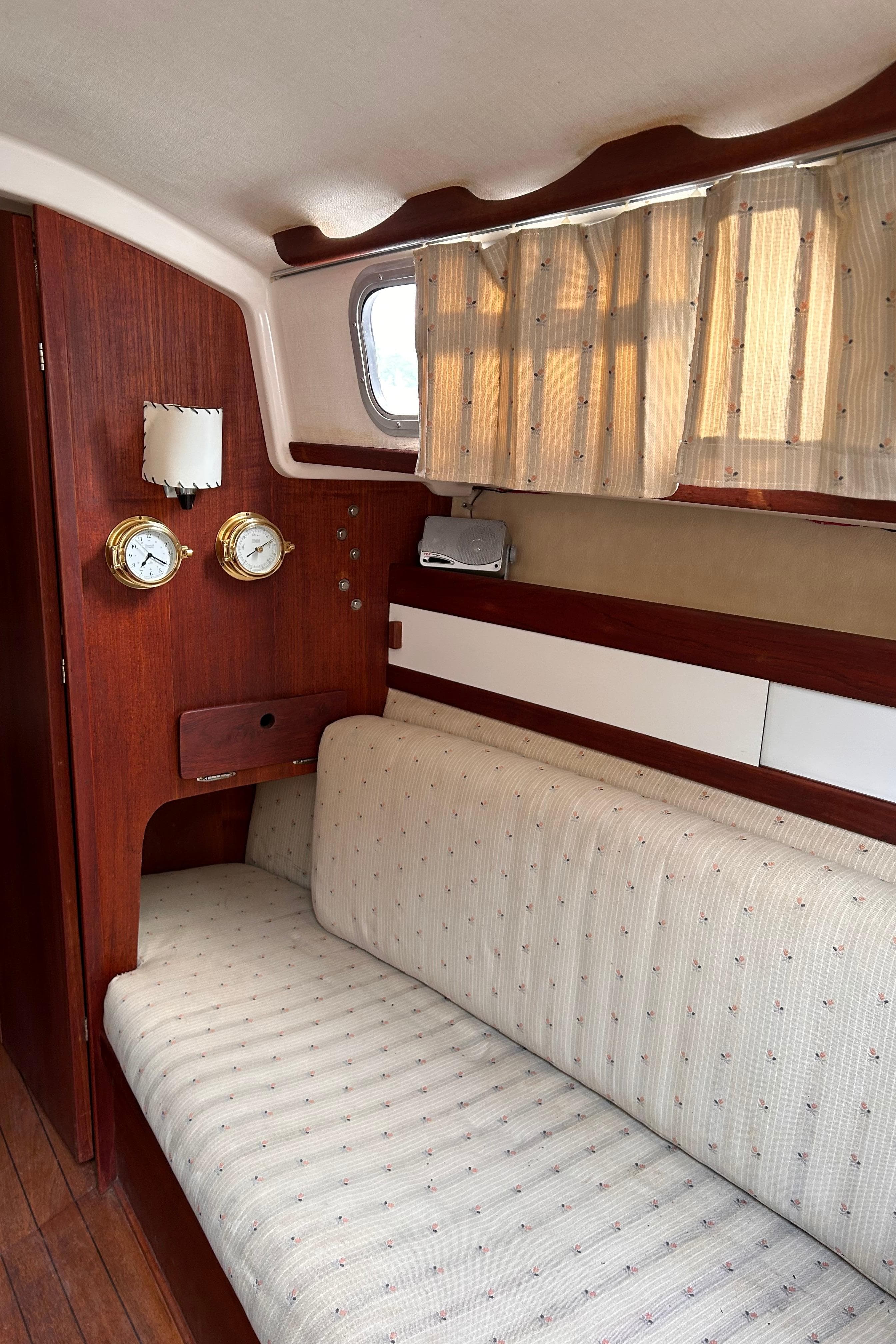 Interior of a 1979 Sabre 28-2 sailboat with wooden paneling and cushioned seating.