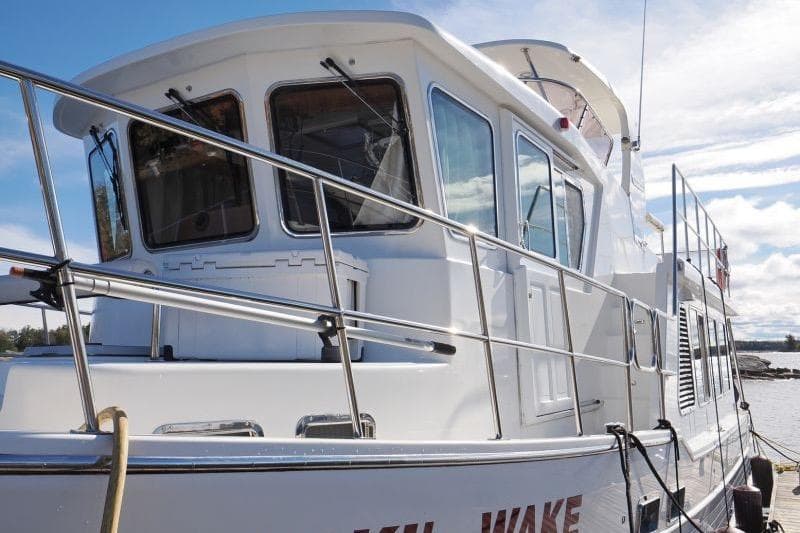 2016 North Pacific 45 Pilothouse yacht docked under a clear sky.