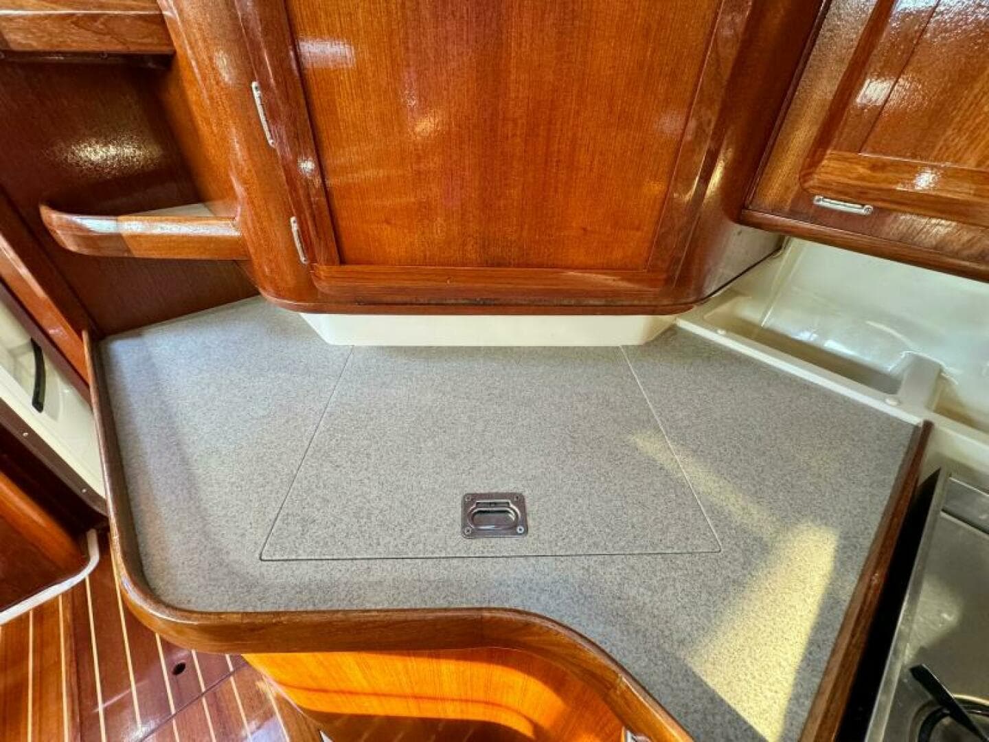 Wooden cabinetry and countertop in a 1995 Hunter 430 yacht interior.