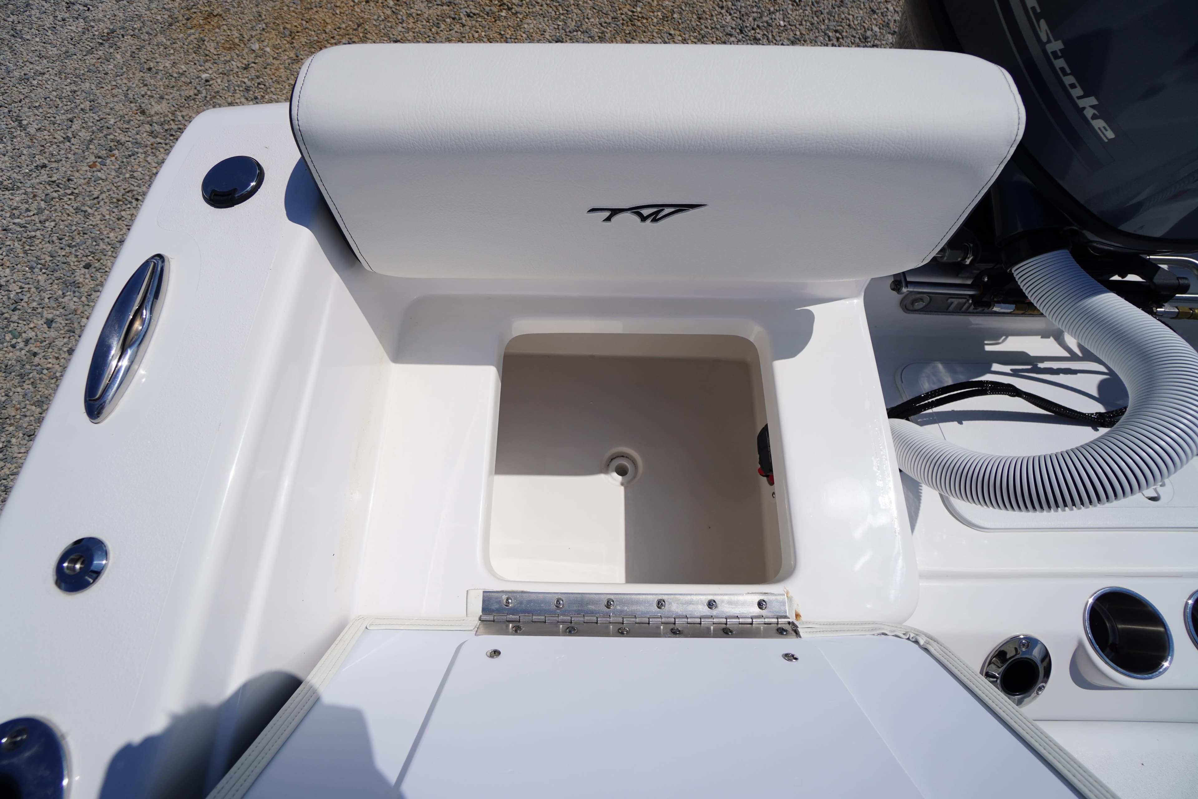 2025 Tidewater 198 CC Adventure boat storage compartment with white cushioned seat.