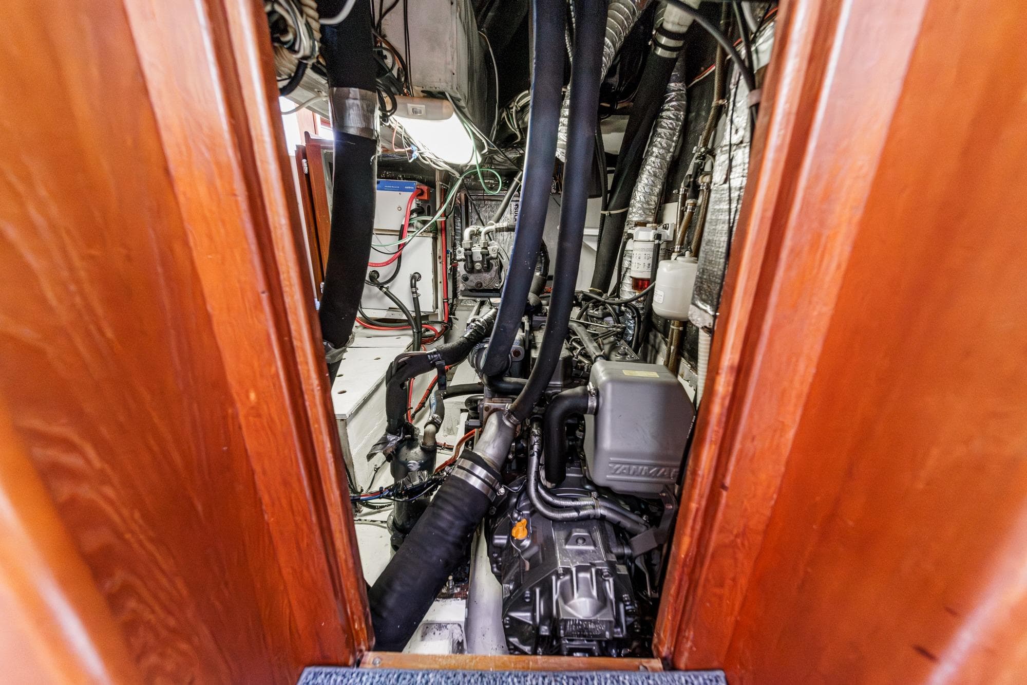 Engine room of 1992 Morgan 45 Catalina sailboat with visible machinery and wiring.