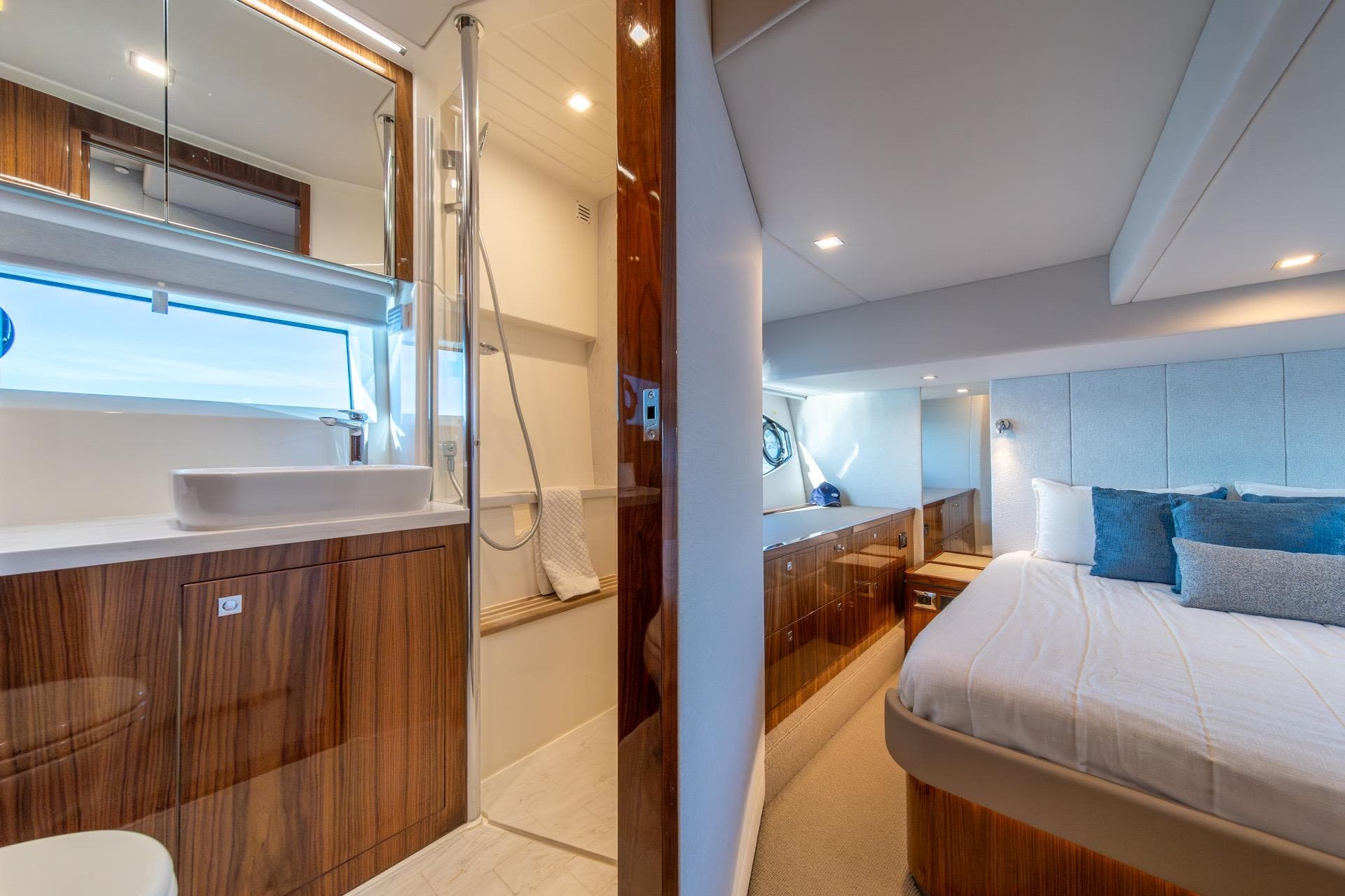 Luxurious interior of 2023 Riviera 4600 Sport Yacht Platinum Edition, featuring elegant bedroom and bathroom.