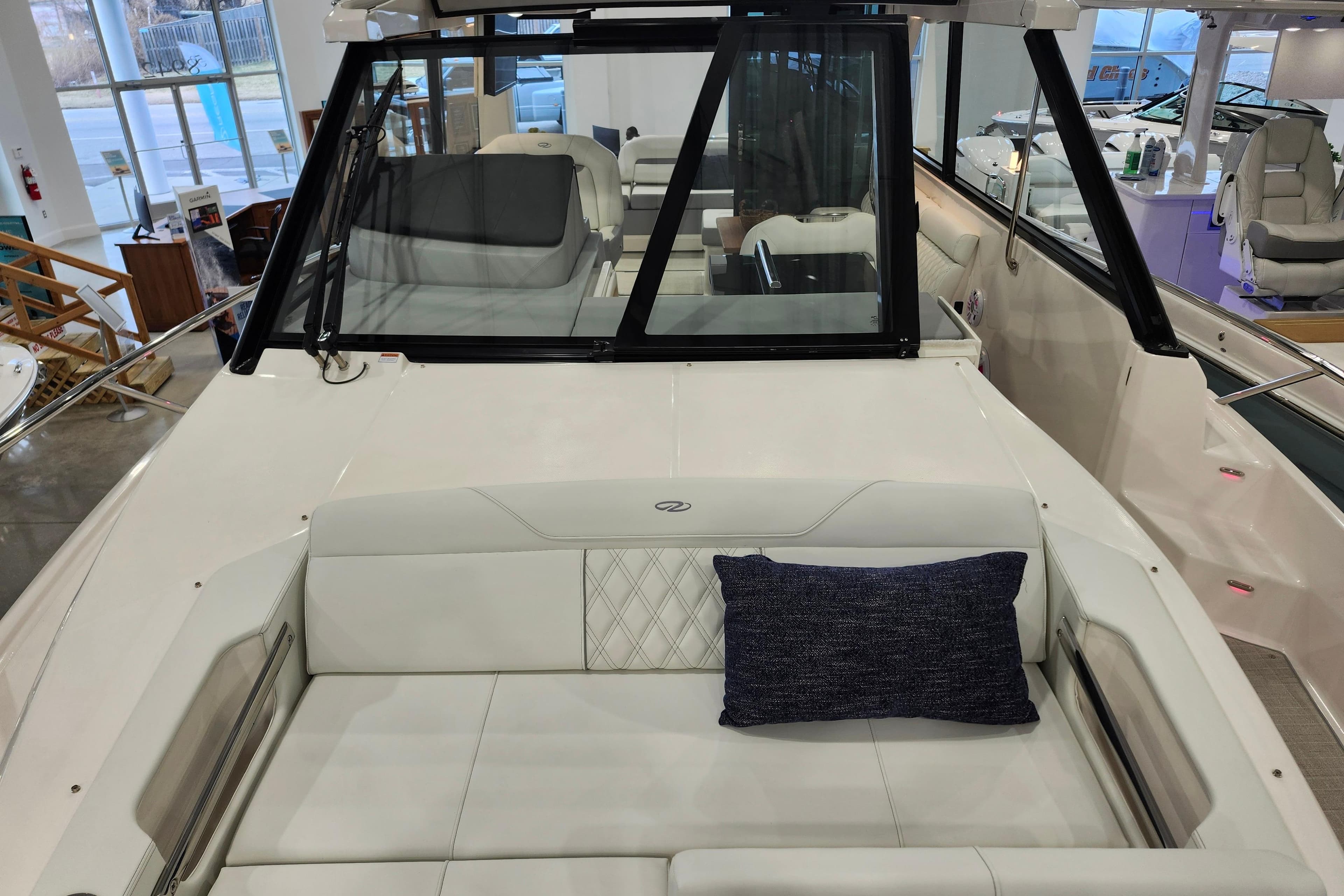 2025 Regal 36 XO boat interior with white seating and blue cushion.