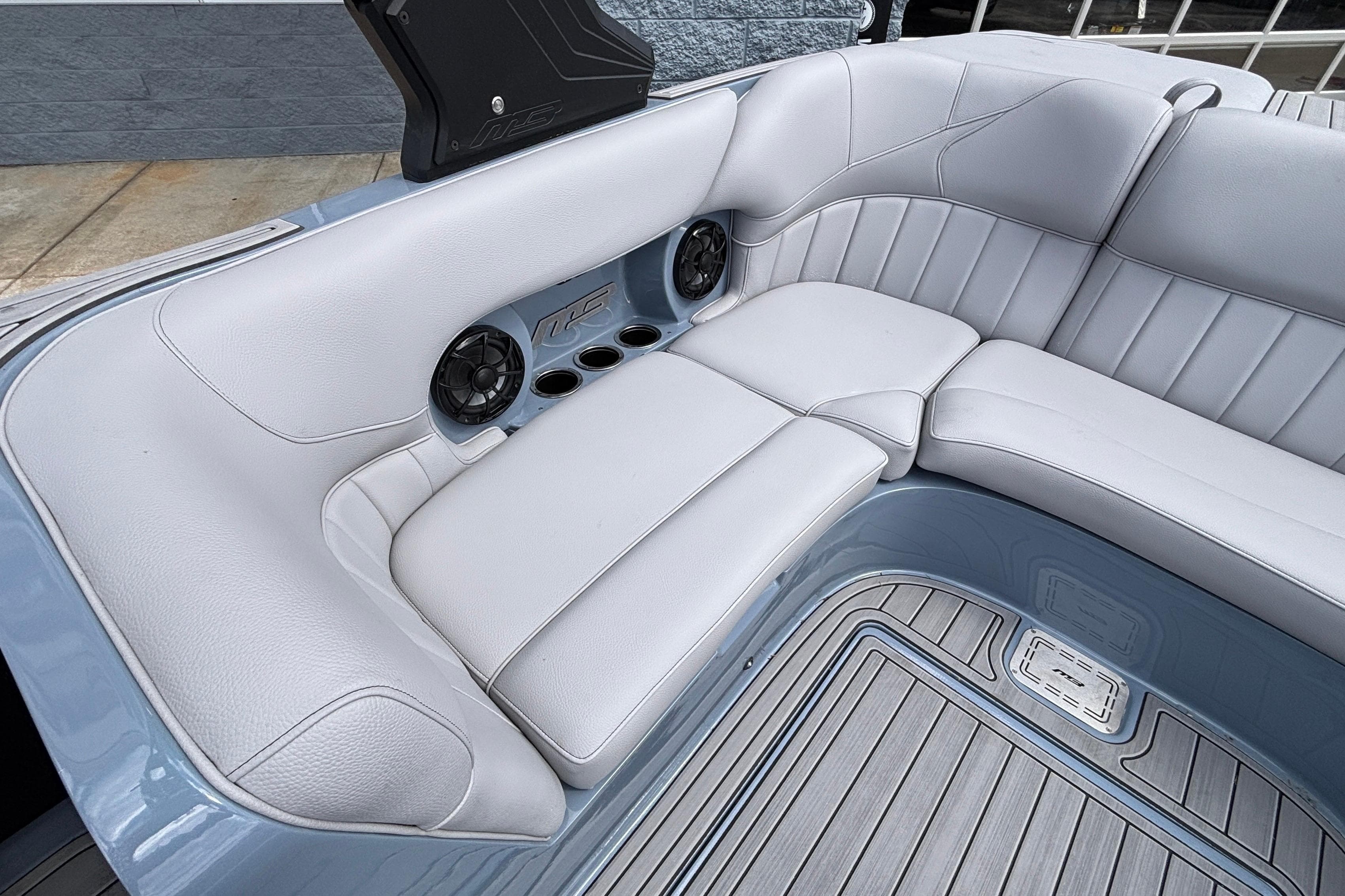Luxurious seating in 2026 MB B52 23 Classic boat with speakers and cup holders.