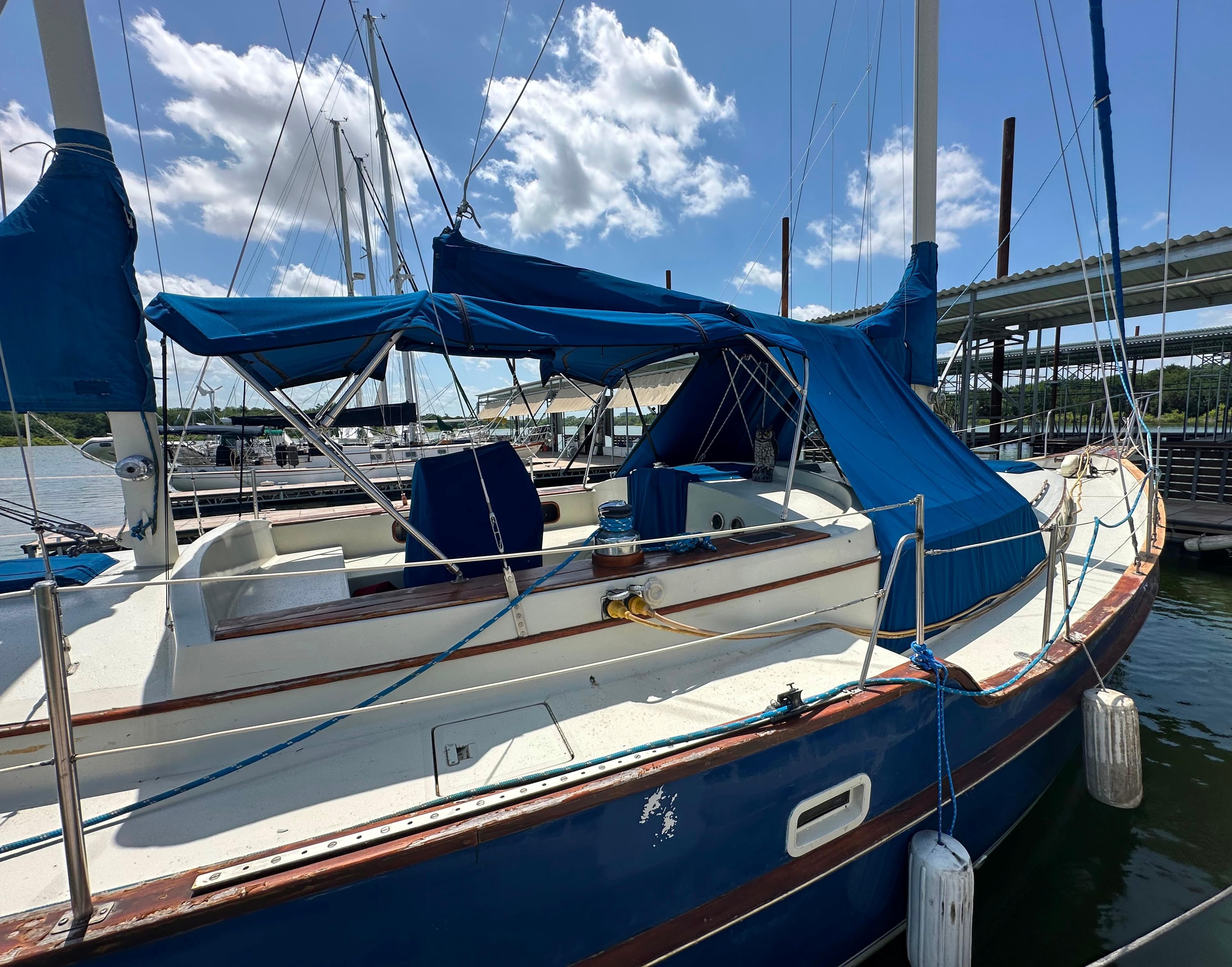 1982 Irwin 46 sailboat docked, featuring blue covers and clear skies.