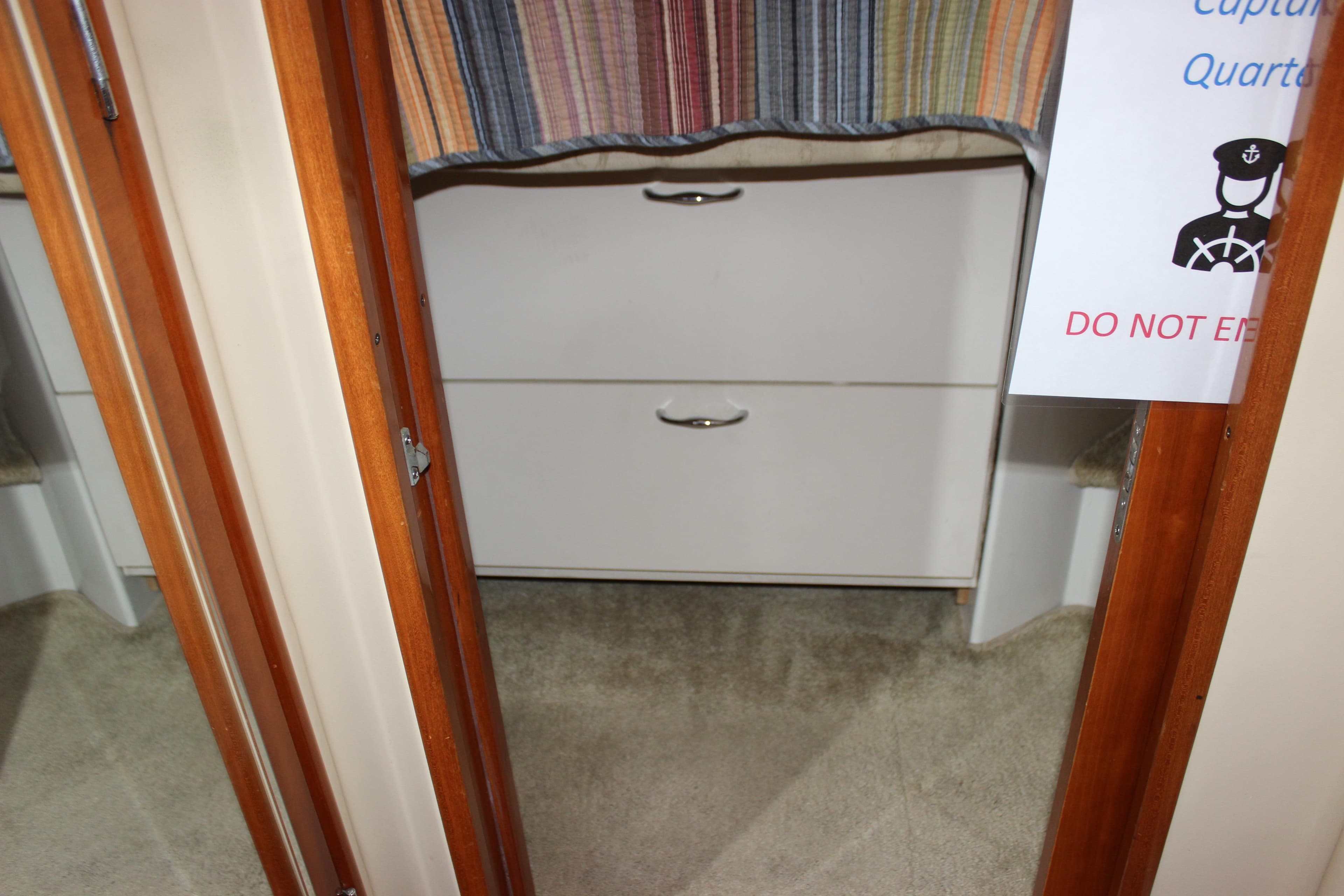 Interior of 2003 Carver 36 Super Sport, showing cabin entrance with drawers and sign.