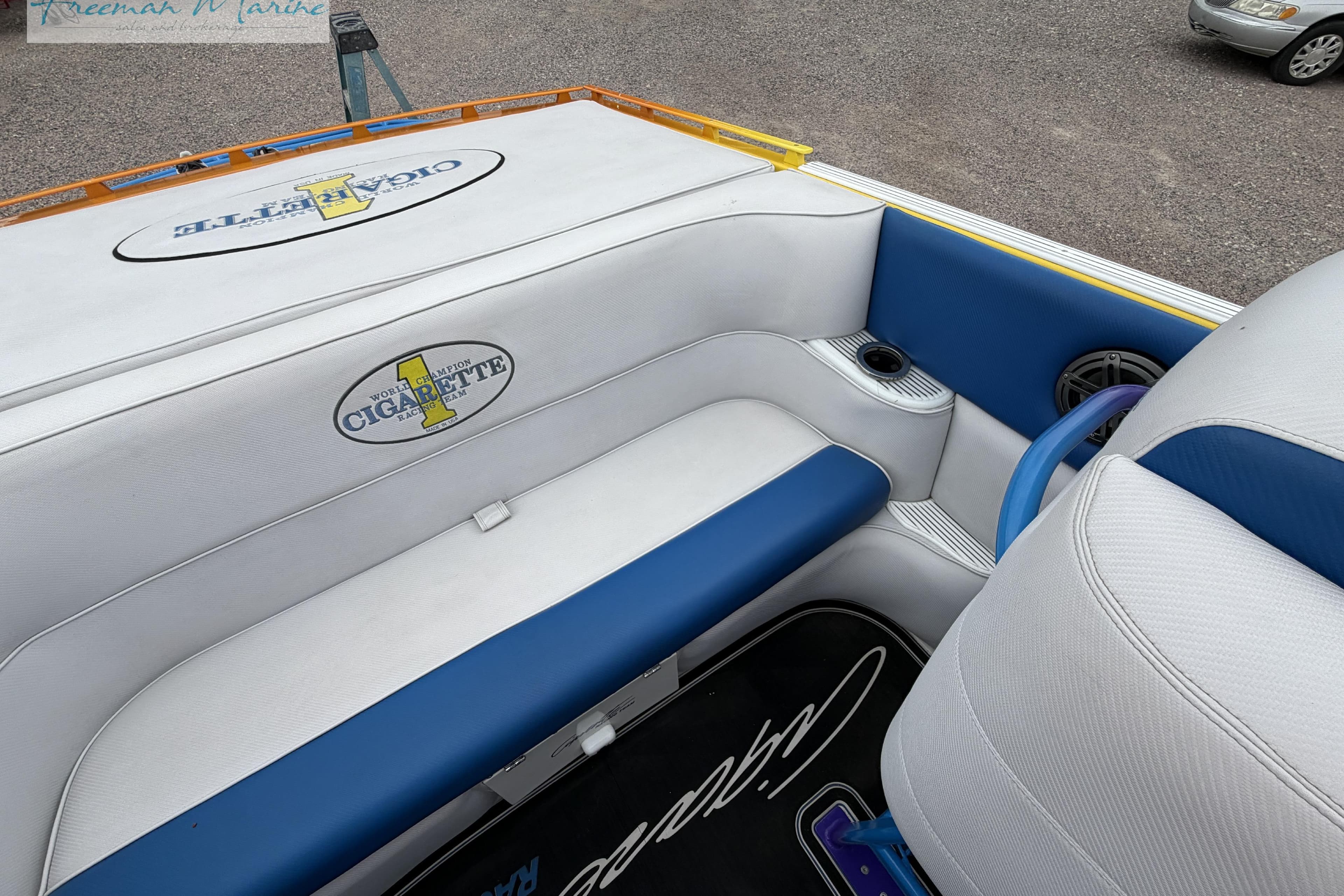 Interior of a 2000 Cigarette 30' Mystique boat with blue and white seating.
