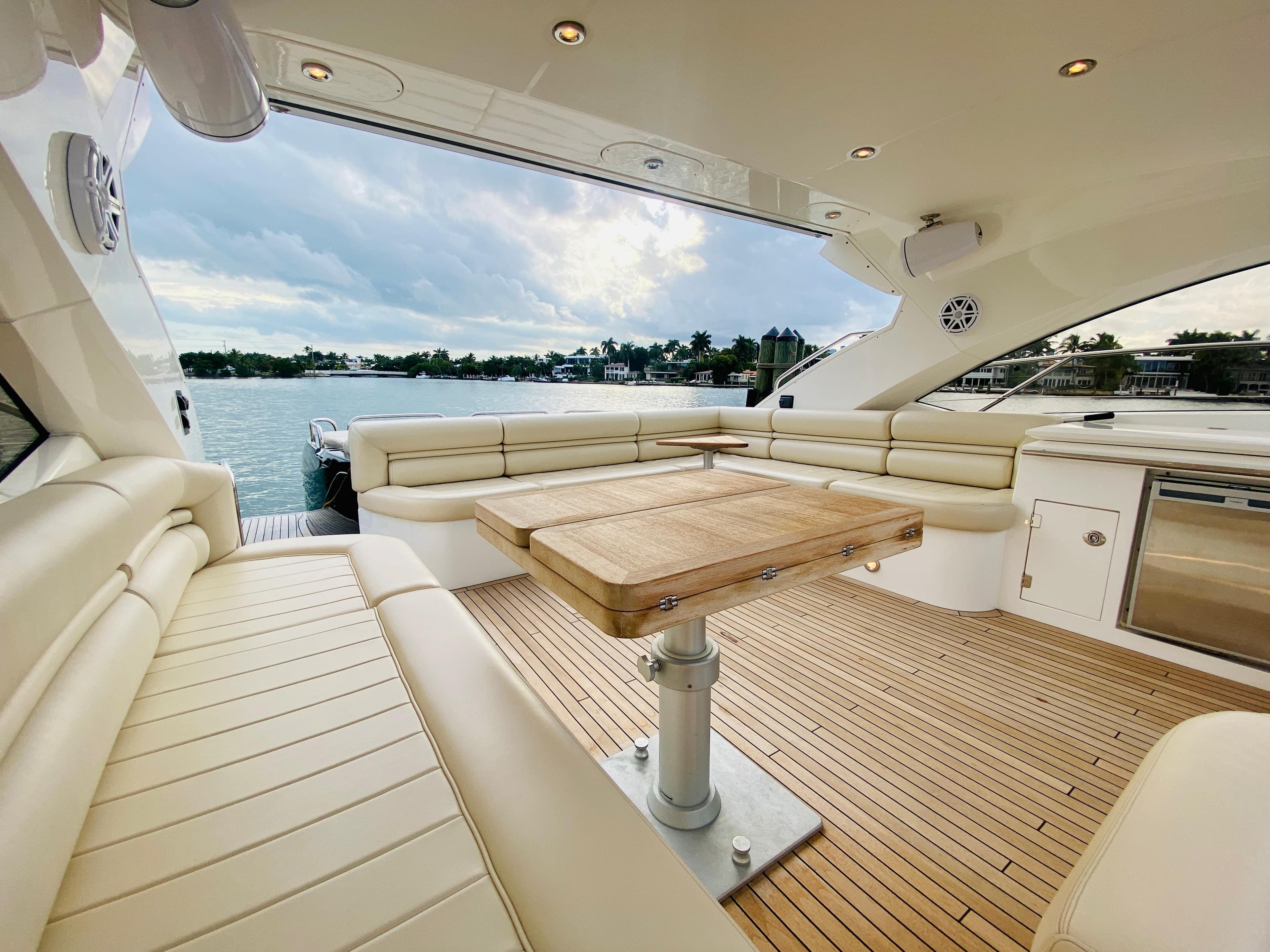 Luxurious 2010 Sunseeker Predator 60 yacht with spacious seating and scenic water view.