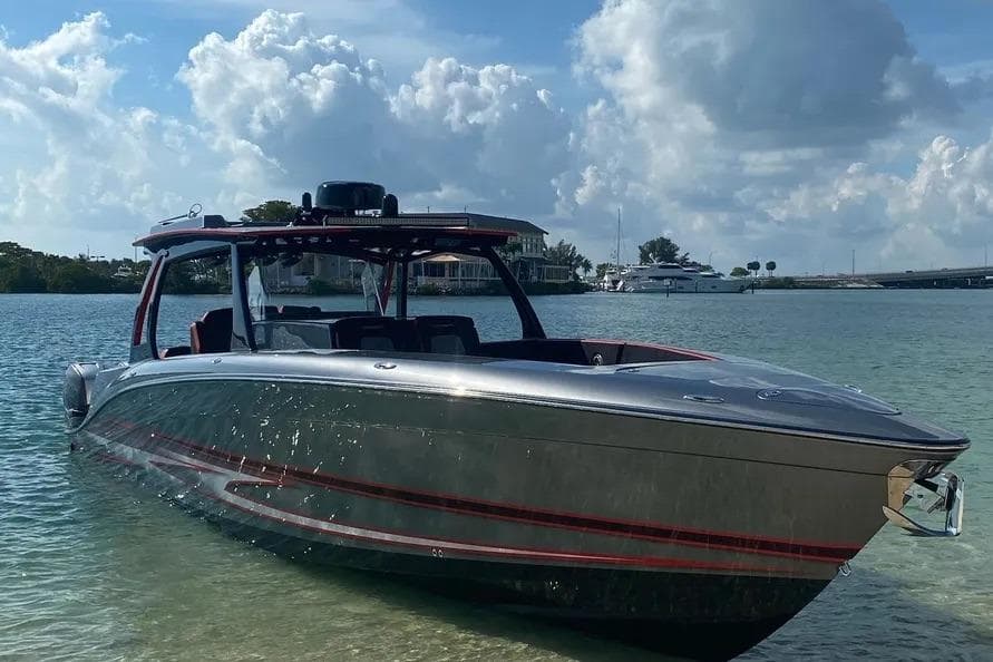 2021 Concept 44' Open Deck boat on calm water under a cloudy sky.
